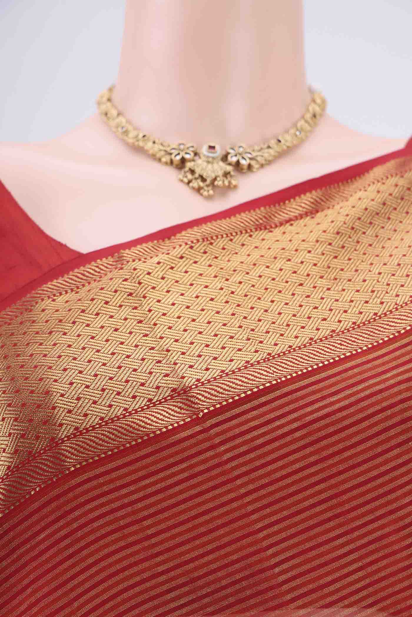 Border image of Orange Maheshwari Silk Cotton Saree with Zari And Thread Butta on the body and Zari Border. 