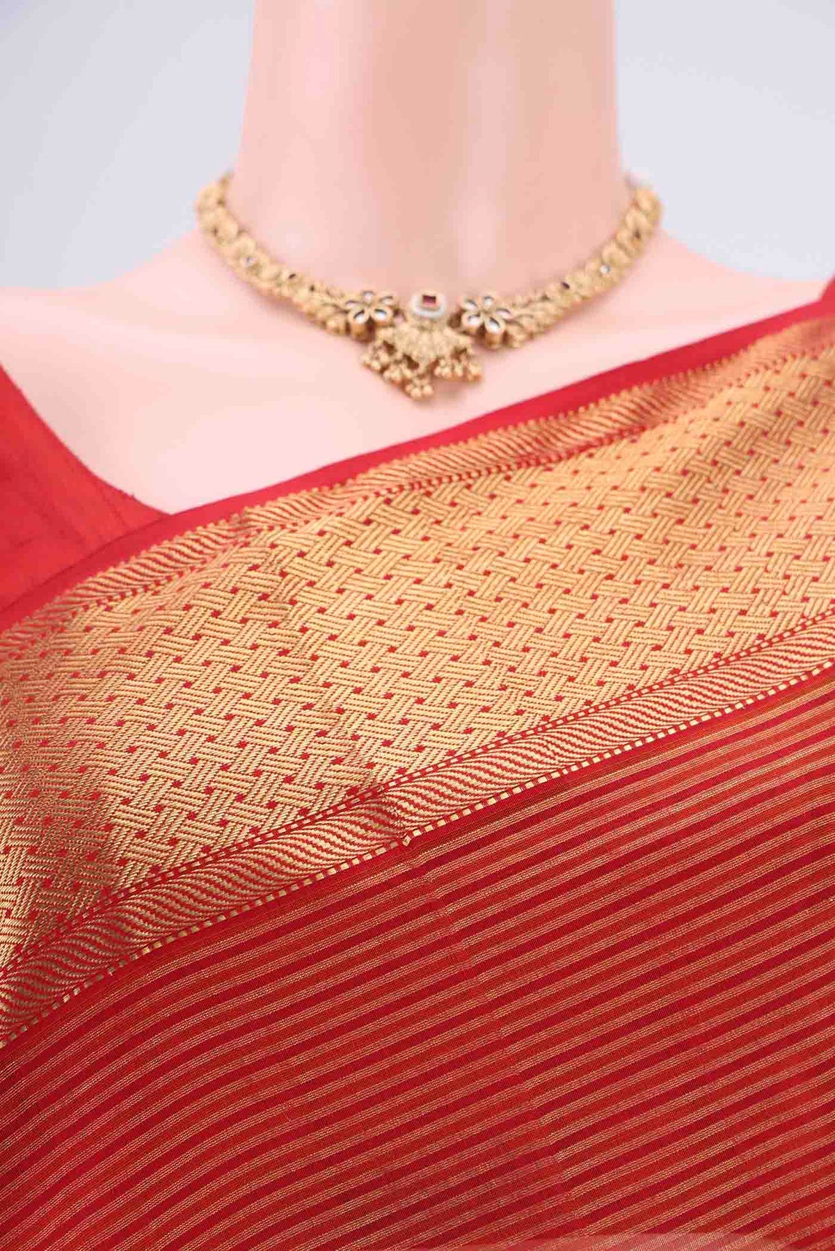 Border image of Orange Maheshwari Silk Cotton Saree with Zari And Thread Butta on the body and Zari Border. 