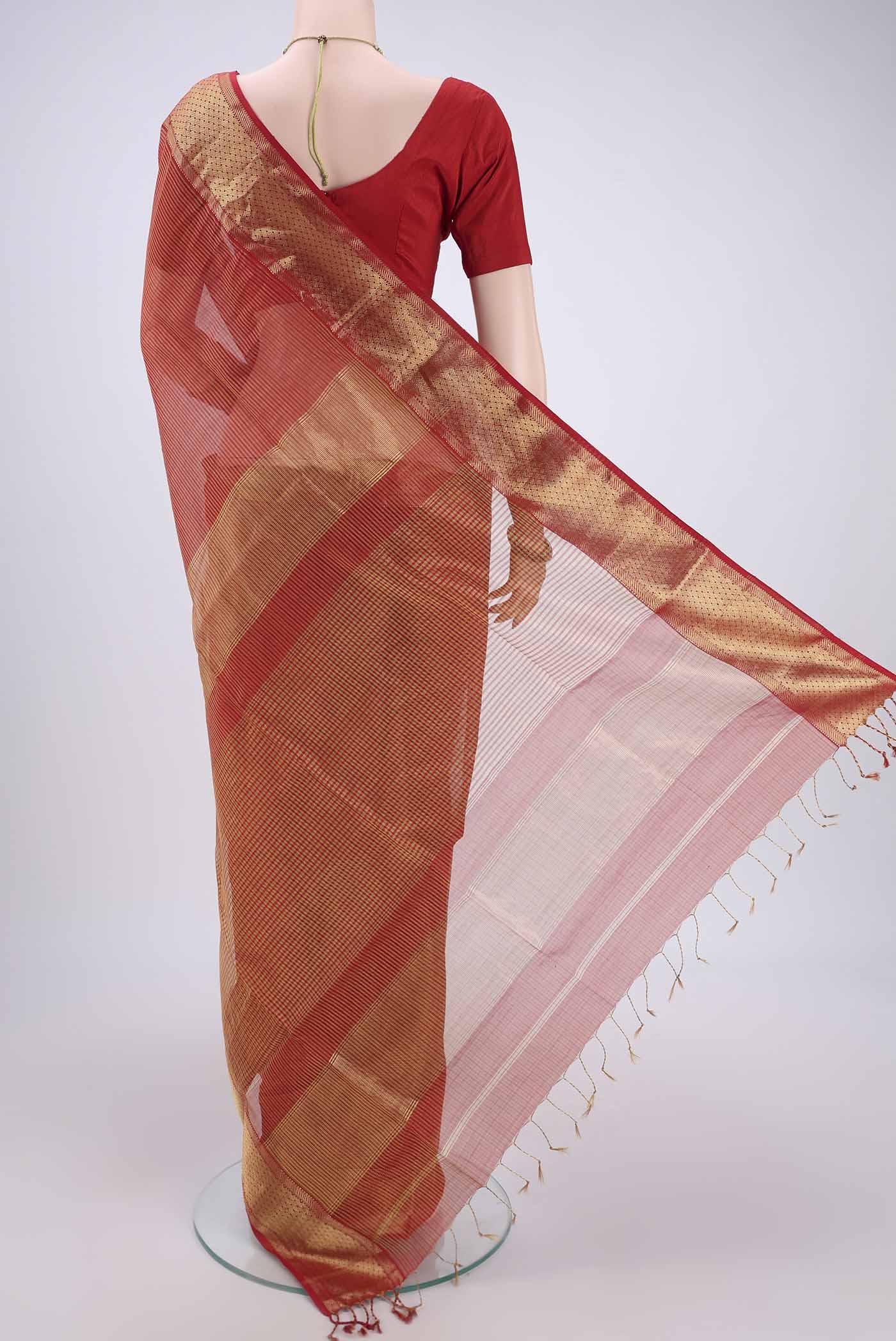 Flat view of Orange Maheshwari Silk Cotton Saree with Zari And Thread Butta on the body and Zari Border. 