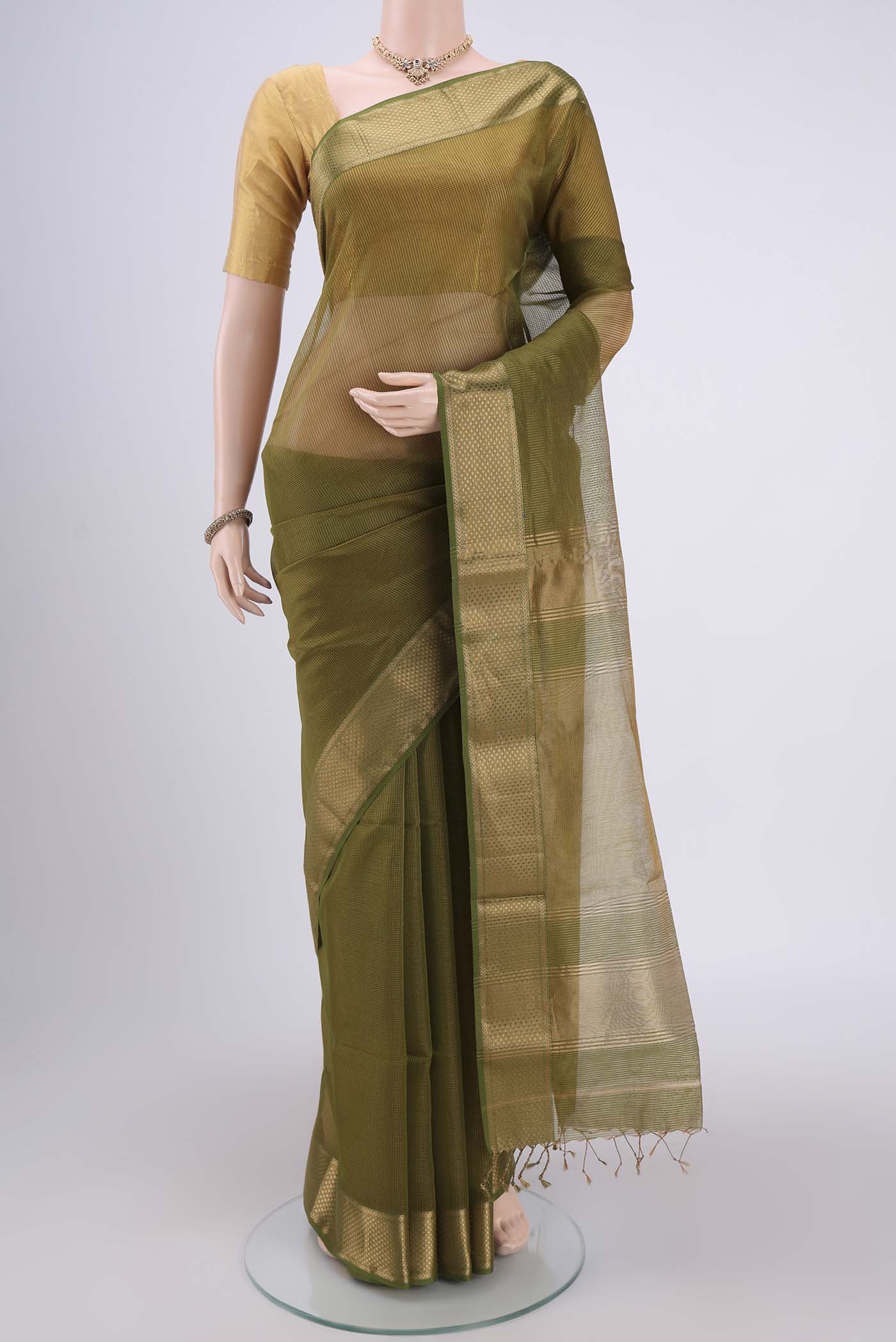 Mehandi Green Maheshwari Silk Cotton Saree with Zari And Thread Butta on the body and Zari Border.  displayed on a mannequin