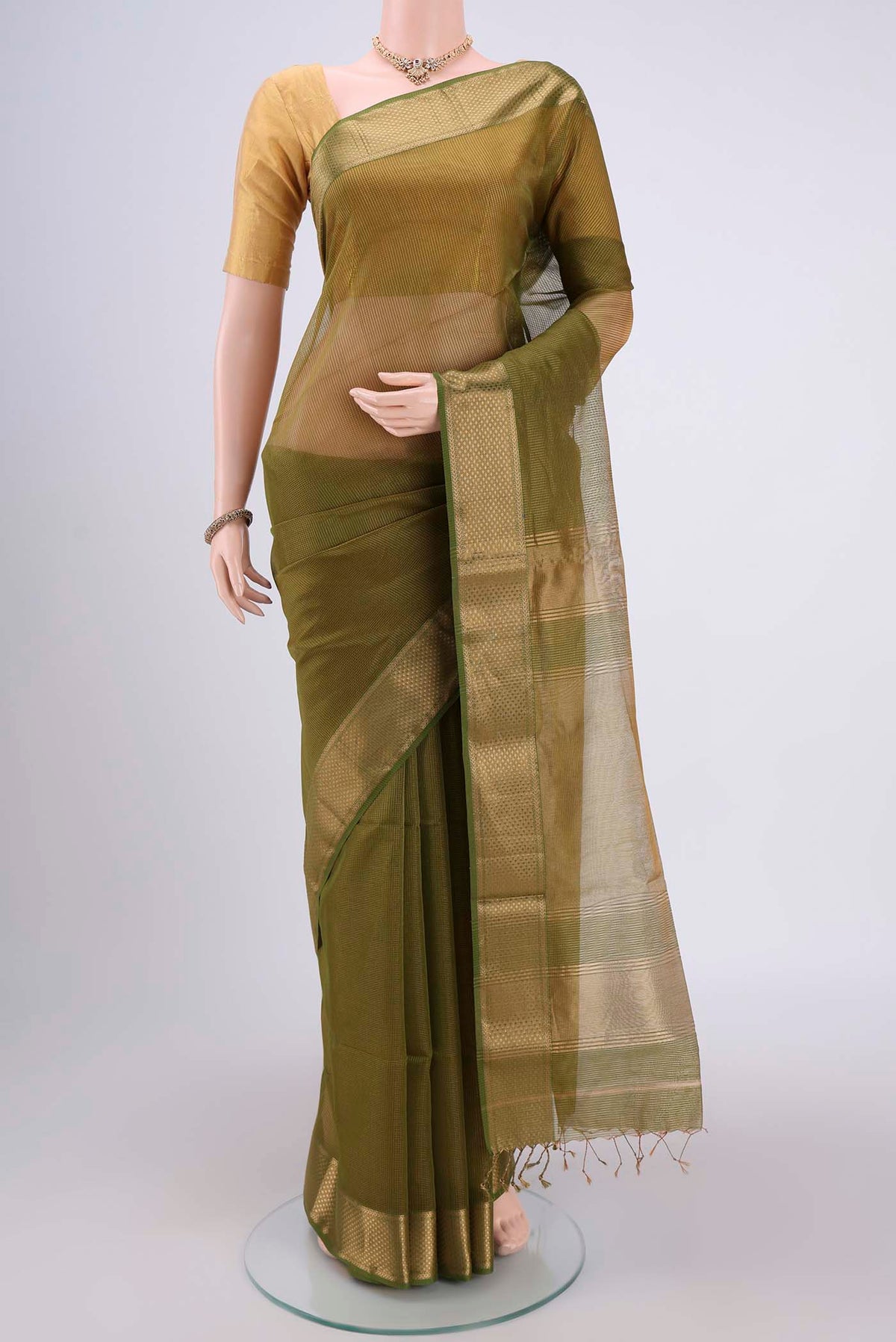 Mehandi Green Maheshwari Silk Cotton Saree with Zari And Thread Butta on the body and Zari Border.  displayed on a mannequin