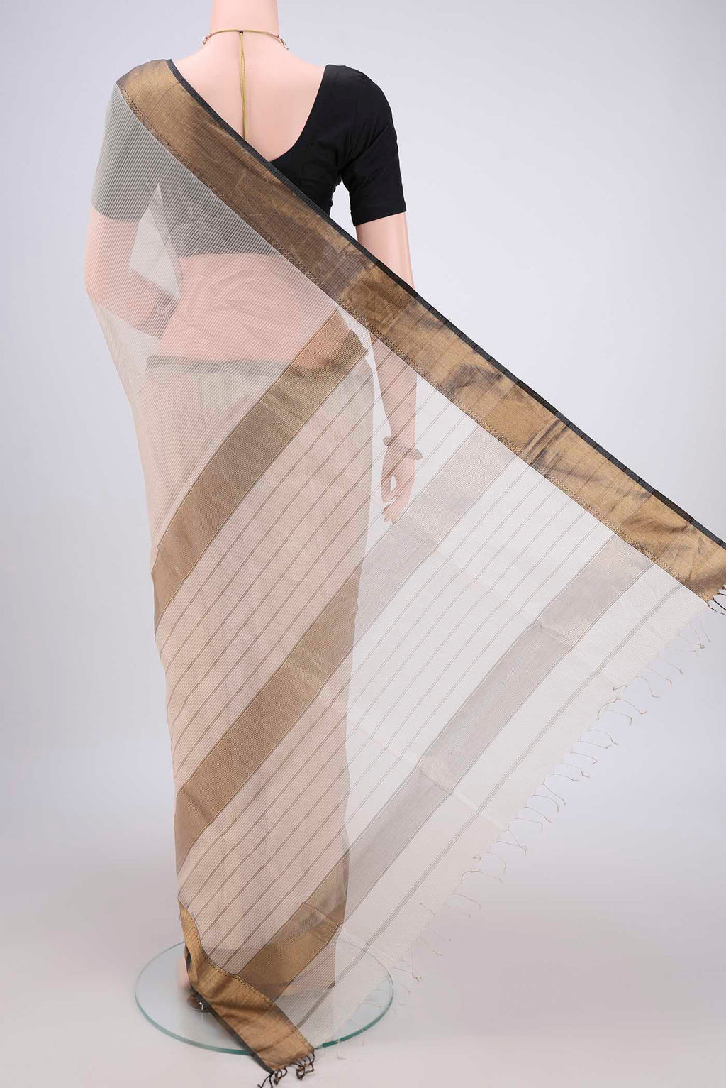 Flat view of Beige Maheshwari Silk Cotton Saree with Checked design on the body and Zari Border. 