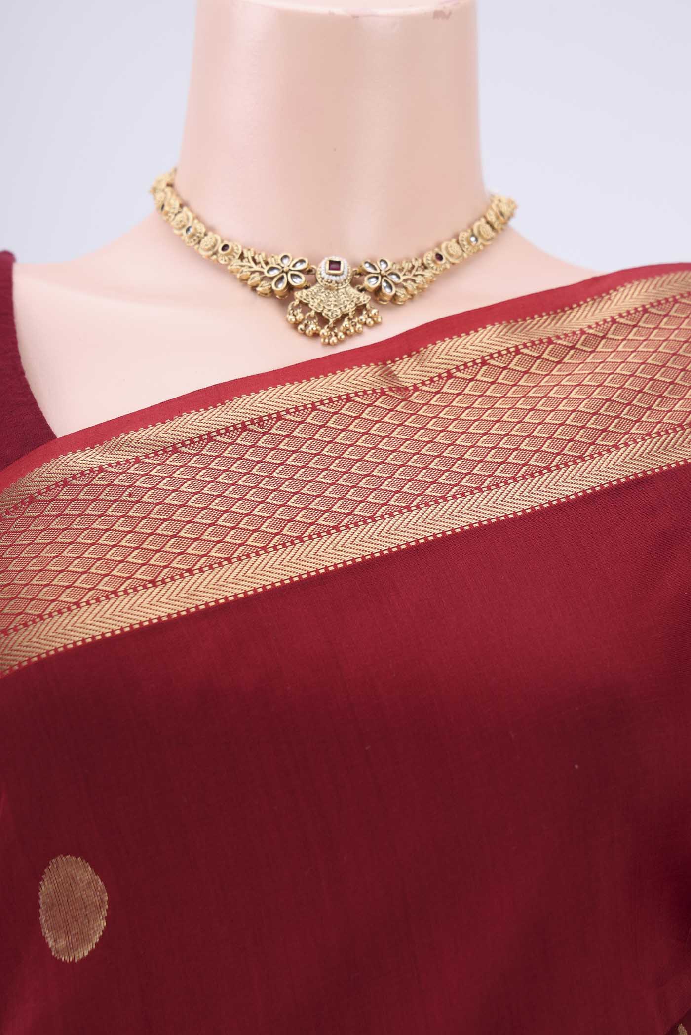 Border image of Maroon Maheshwari Silk Cotton Saree with Polka Dots on the body and Zari Border. 