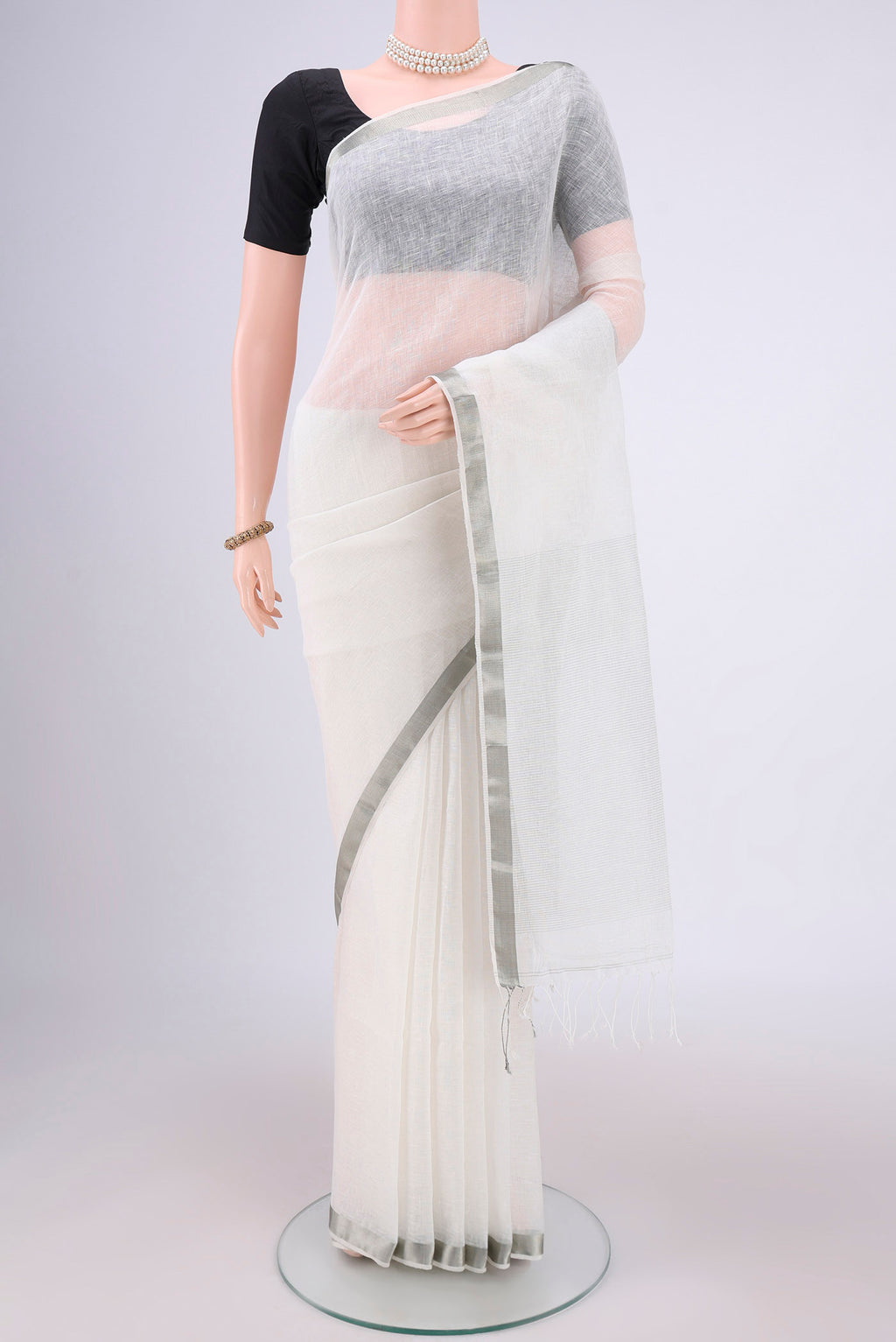 Off White Linen Saree with Plain Body and Zari Border.  displayed on a mannequin