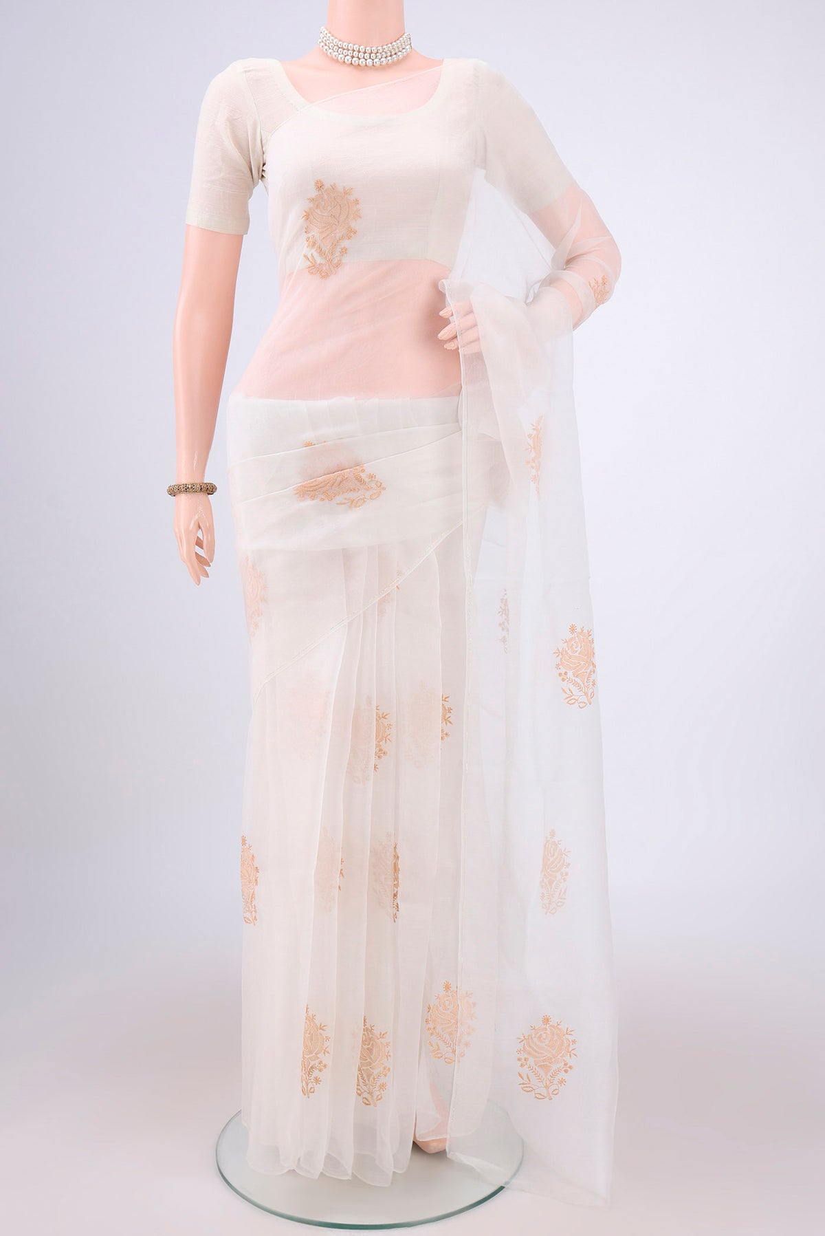 White Organza Silk Saree with Embroidery on the body and Thin Zari Line.  displayed on a mannequin