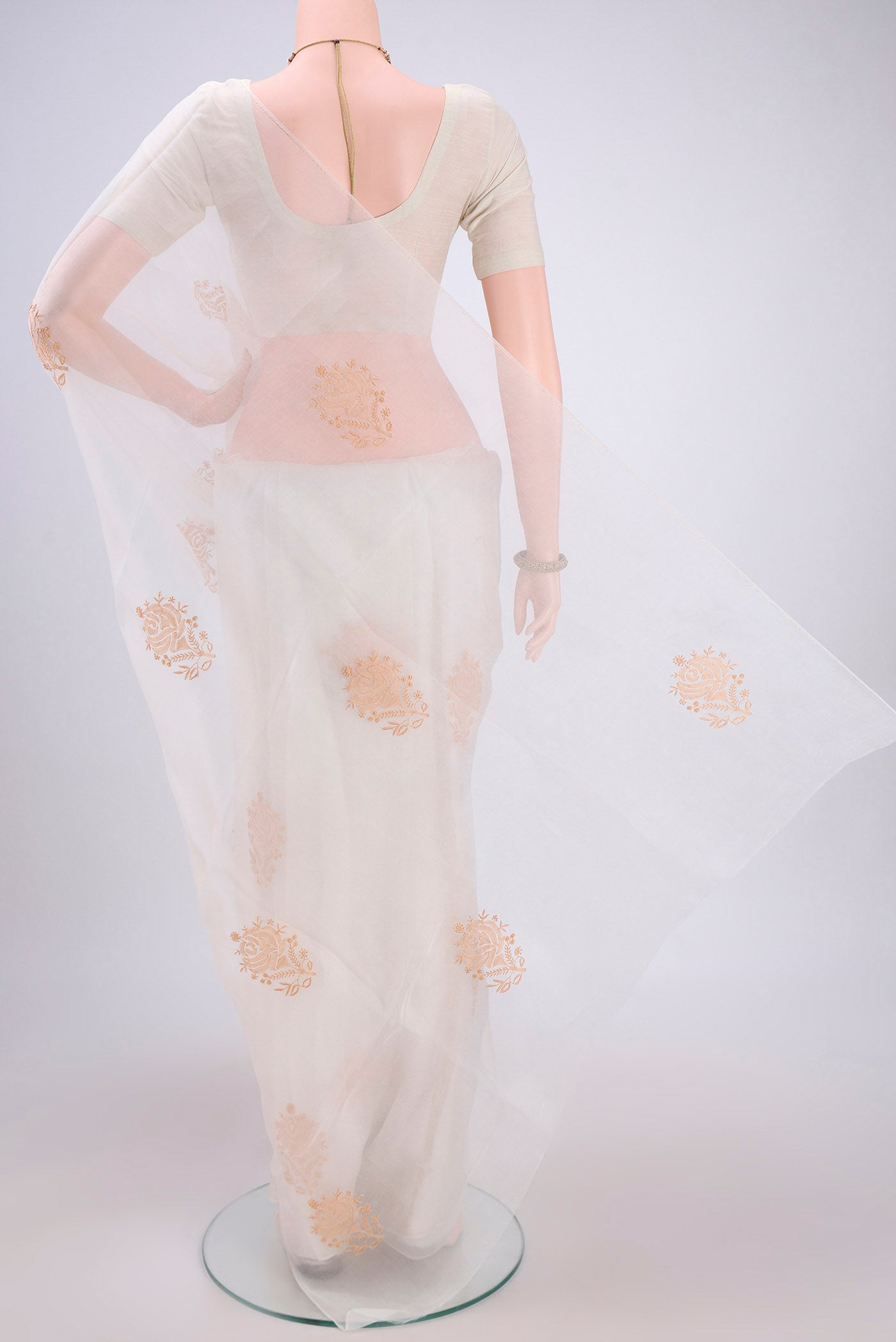 Flat view of White Organza Silk Saree with Embroidery on the body and Thin Zari Line. 