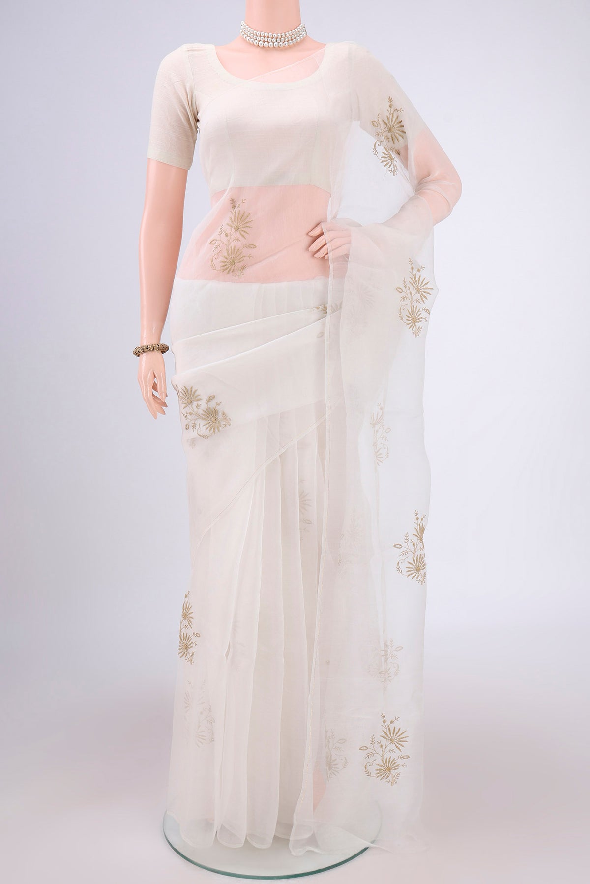 White Organza Silk Saree with Embroidery on the body and Thin Zari Line.  displayed on a mannequin