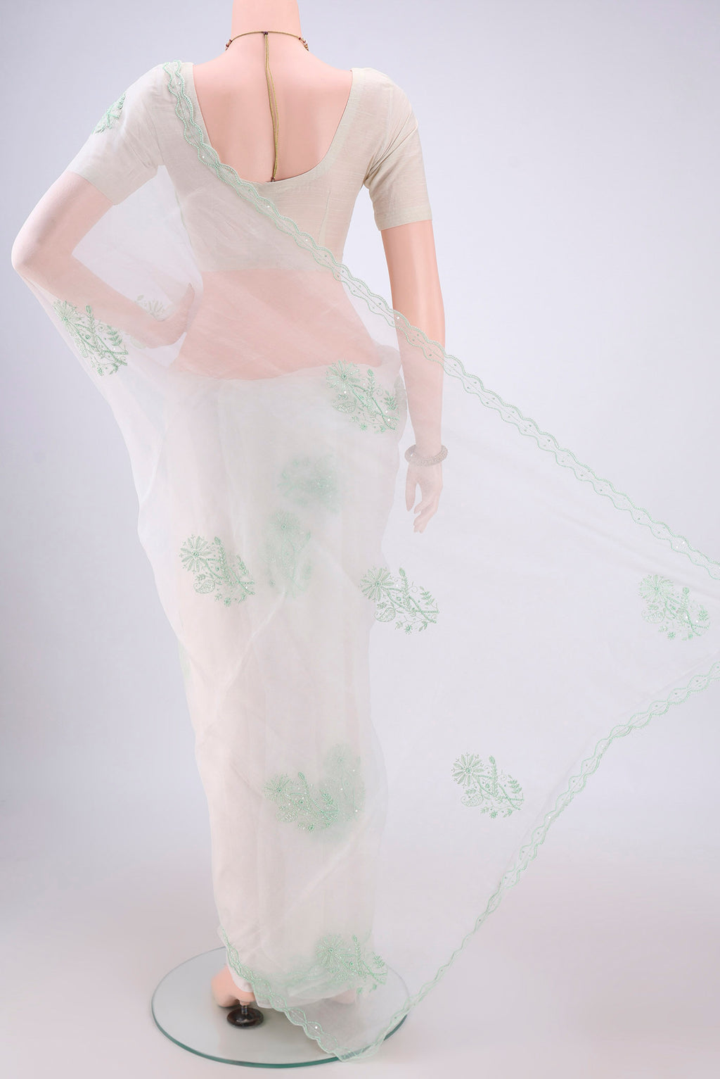 Flat view of White Organza Silk Saree with Embroidery on the body and Thin Zari Line. 