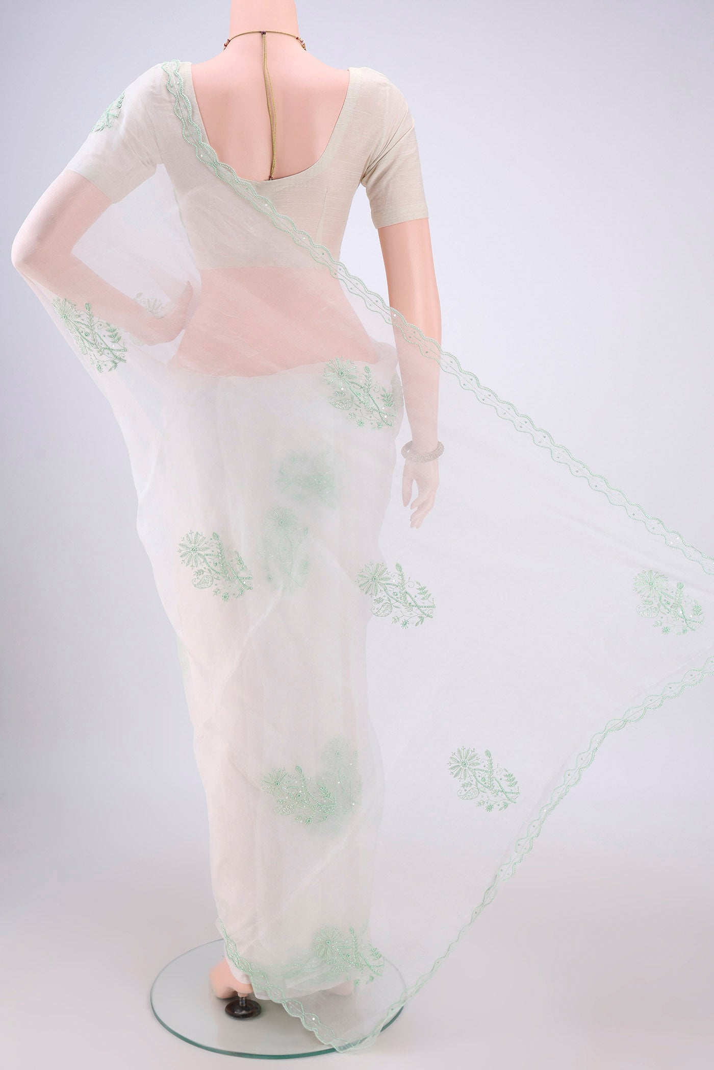 Flat view of White Organza Silk Saree with Embroidery on the body and Thin Zari Line. 