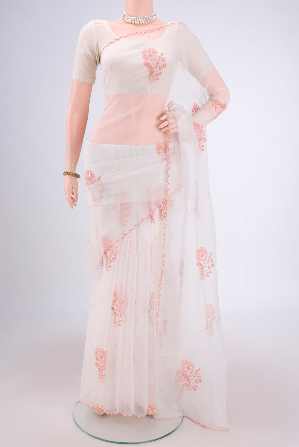 White Organza Silk Saree with Embroidery on the body and Thin Zari Line.  displayed on a mannequin