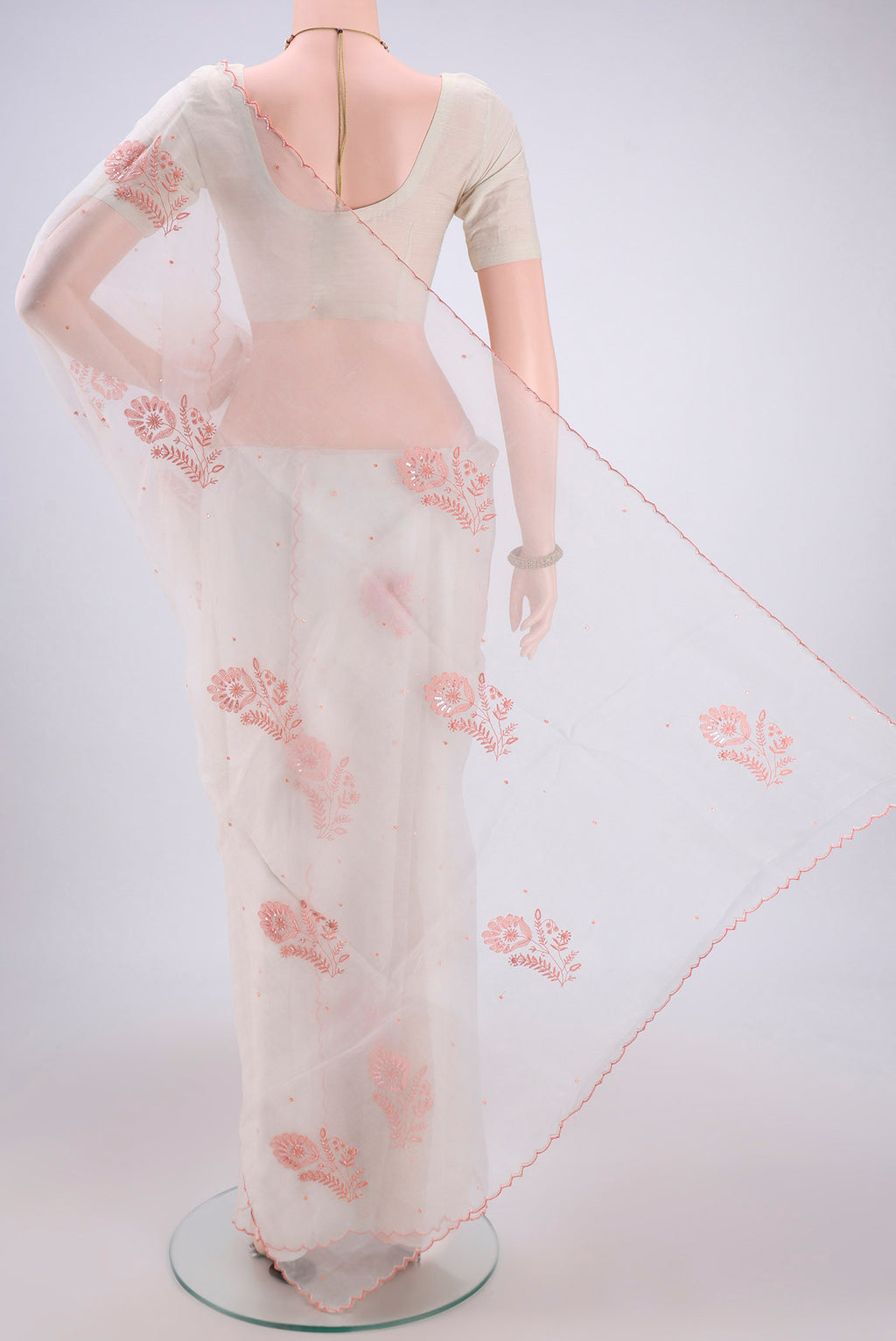 Flat view of White Organza Silk Saree with Embroidery on the body and Thin Zari Line. 