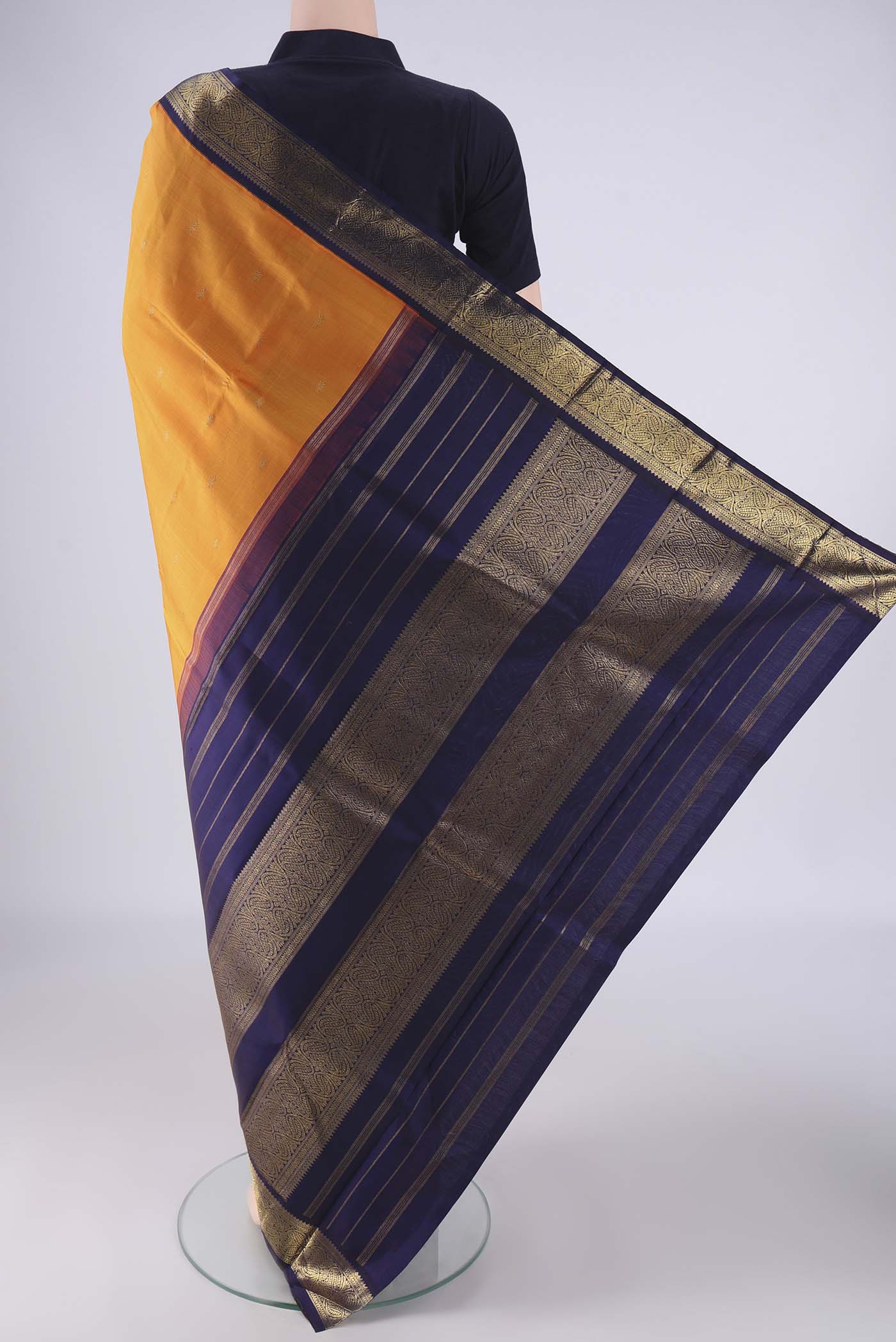 Flat view of Pure Silk Pure Zari Brick Orange Kanjivaram Saree with Zari Butta on the body and Zari Border. 