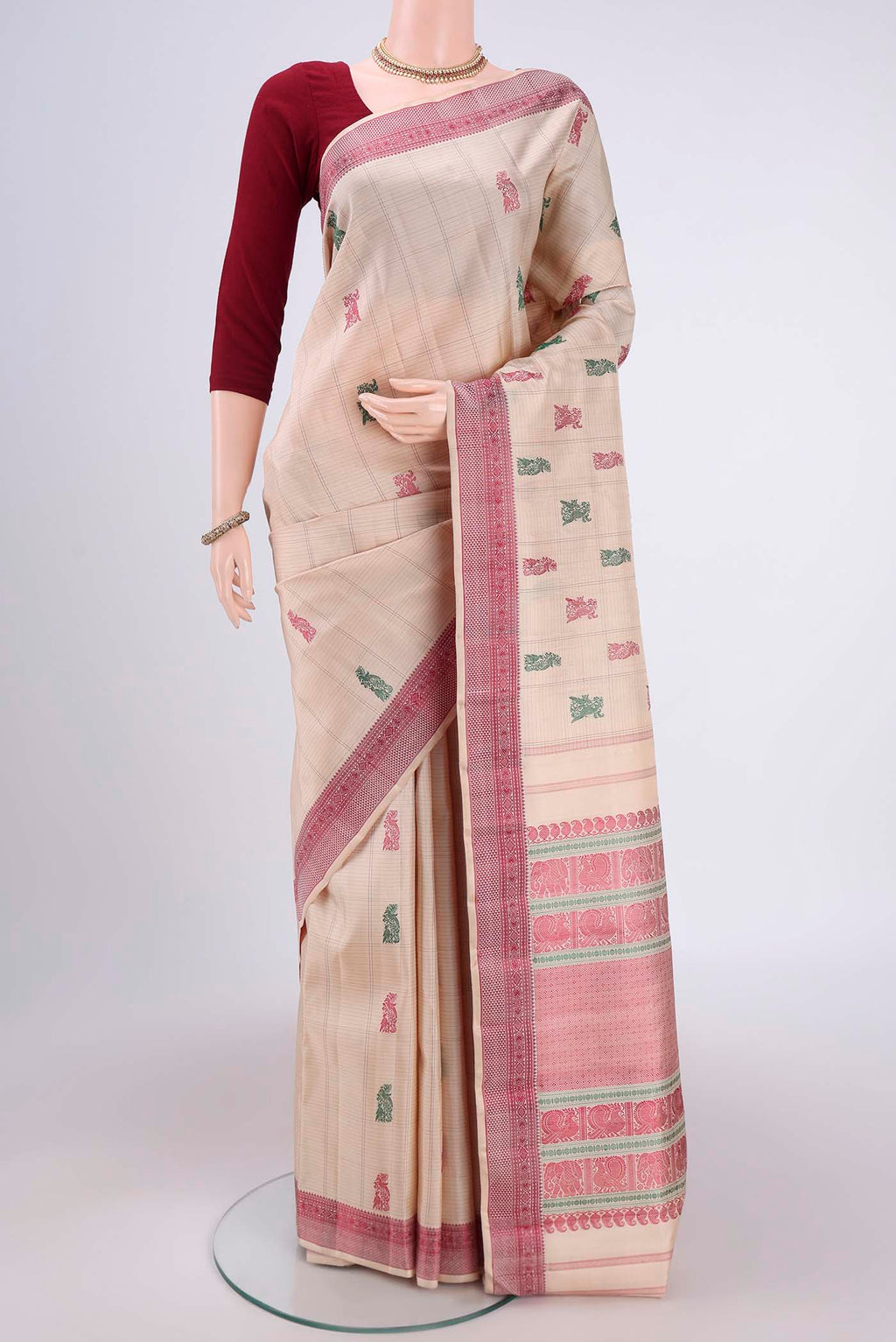 Beige Kanchipuram Saree with Thread Butta on the body and Thread Border.  displayed on a mannequin