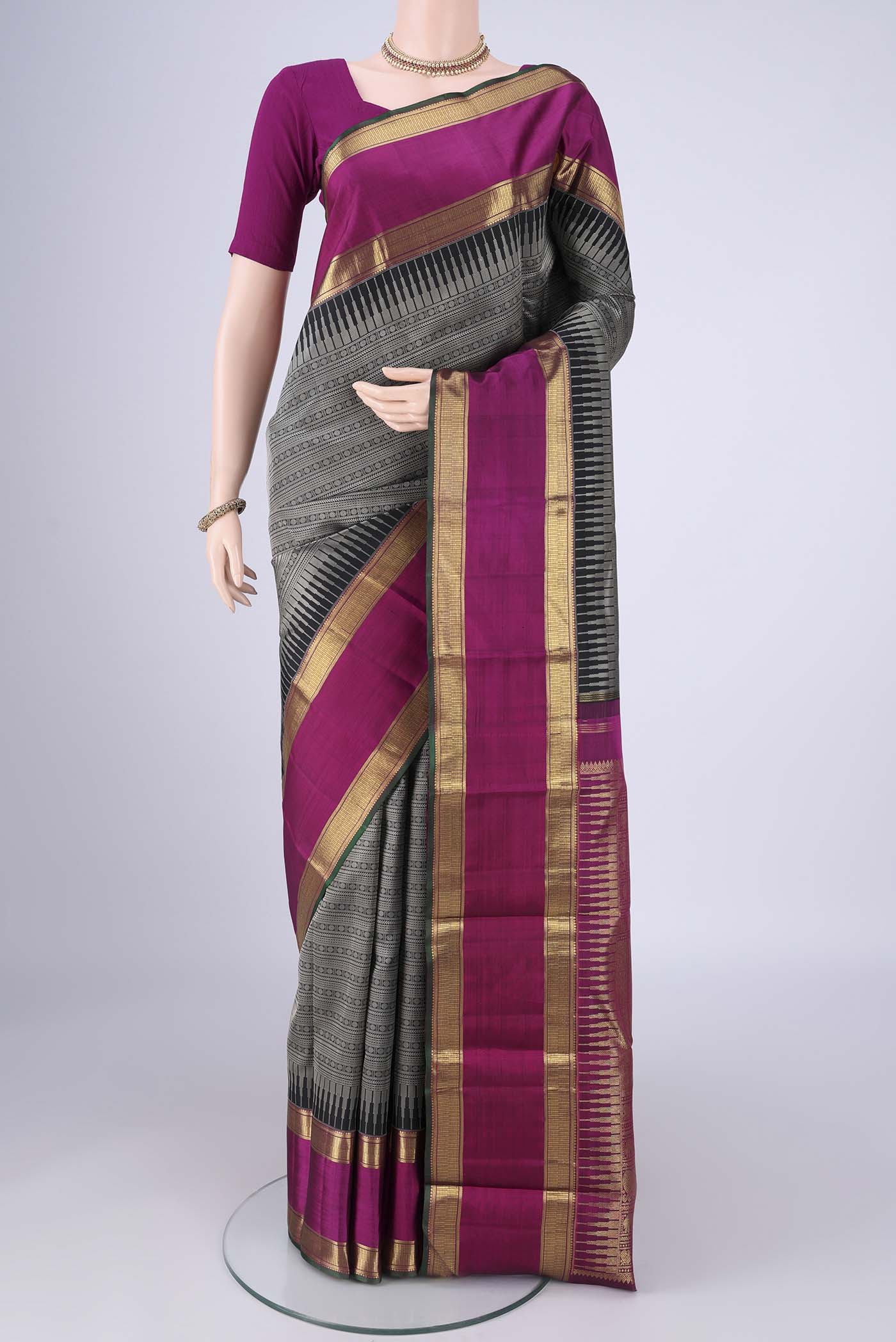 Black Kanjivaram Silk Saree with Jacquard design on the body and Zari Border.  displayed on a mannequin