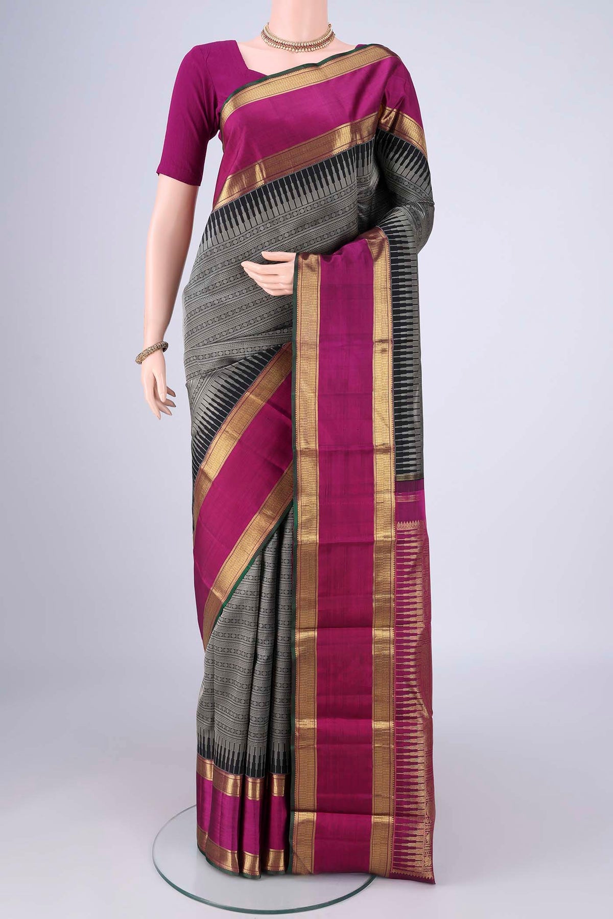 Black Kanjivaram Silk Saree with Jacquard design on the body and Zari Border.  displayed on a mannequin