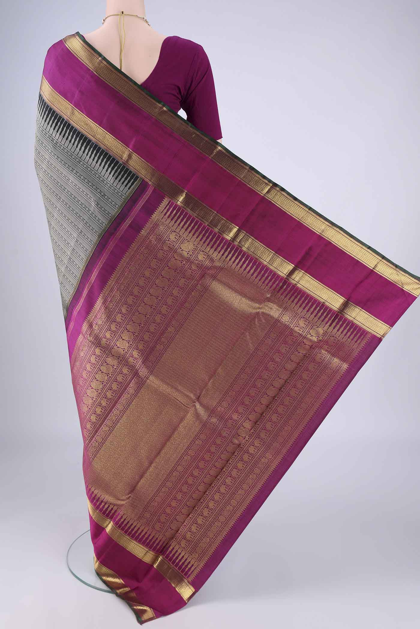 Flat view of Black Kanjivaram Silk Saree with Jacquard design on the body and Zari Border. 