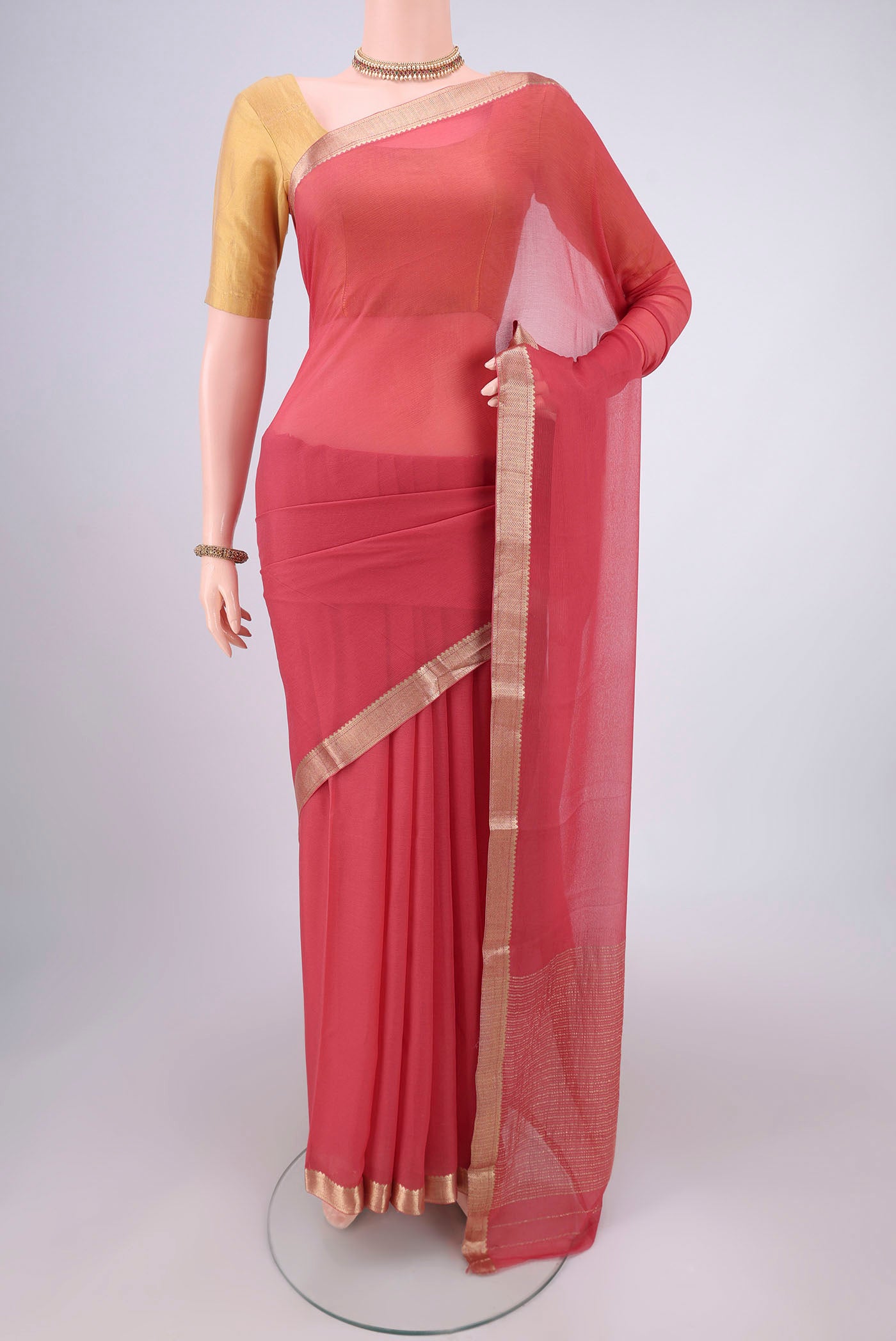 Peach Mysore Chiffon Saree with Plain Body and Zari Border.  displayed on a mannequin