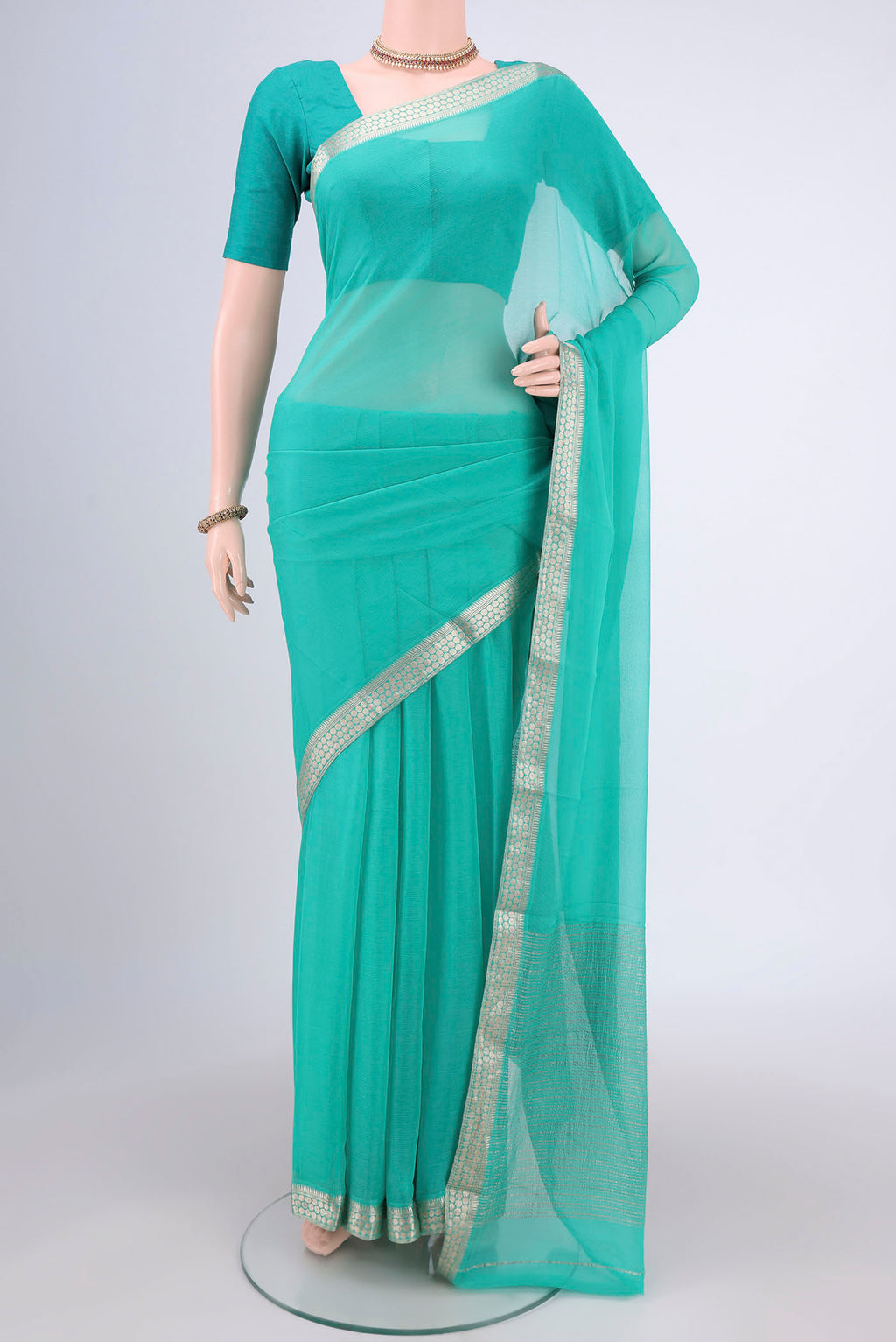 Sea Green Mysore Chiffon Saree with Plain Body and Zari Border.  displayed on a mannequin