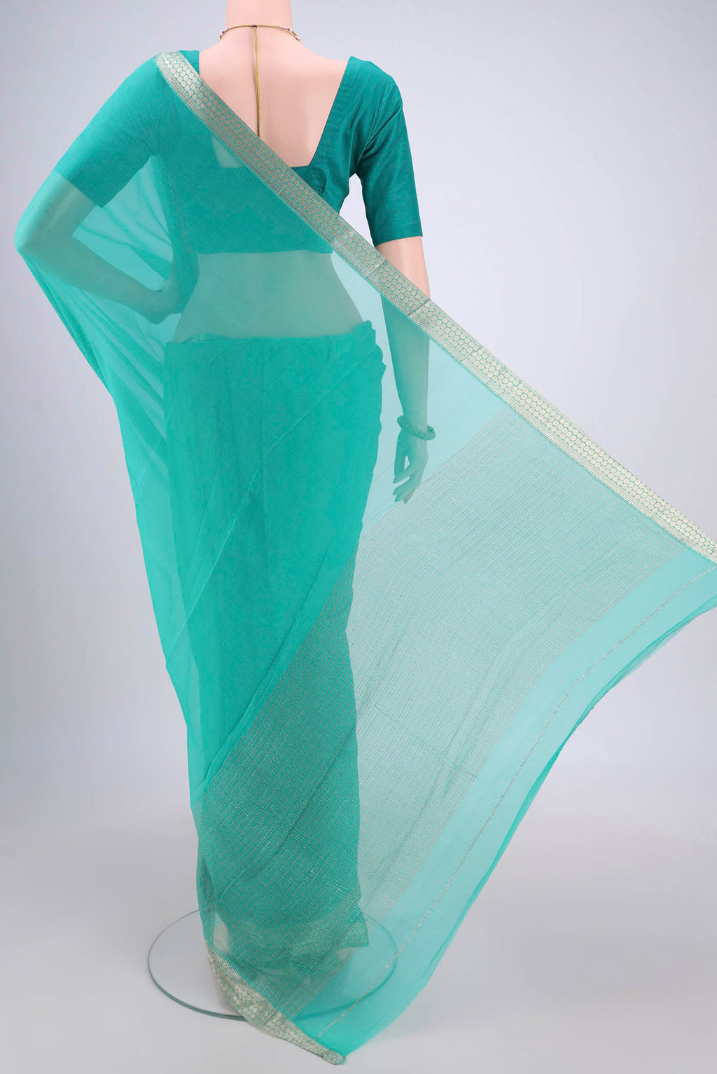 Flat view of Sea Green Mysore Chiffon Saree with Plain Body and Zari Border. 