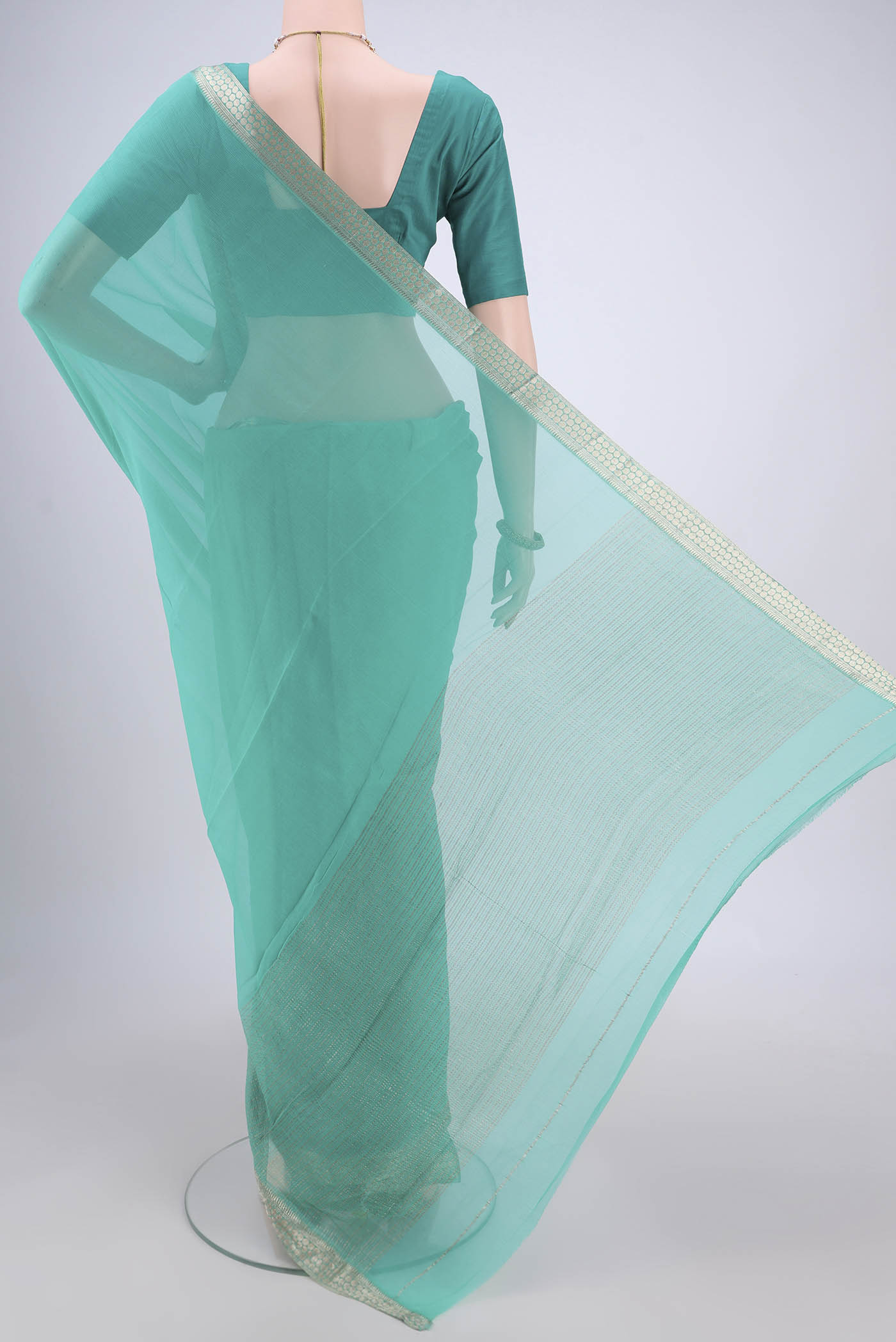 Flat view of Sea Green Mysore Chiffon Saree with Plain Body and Zari Border. 
