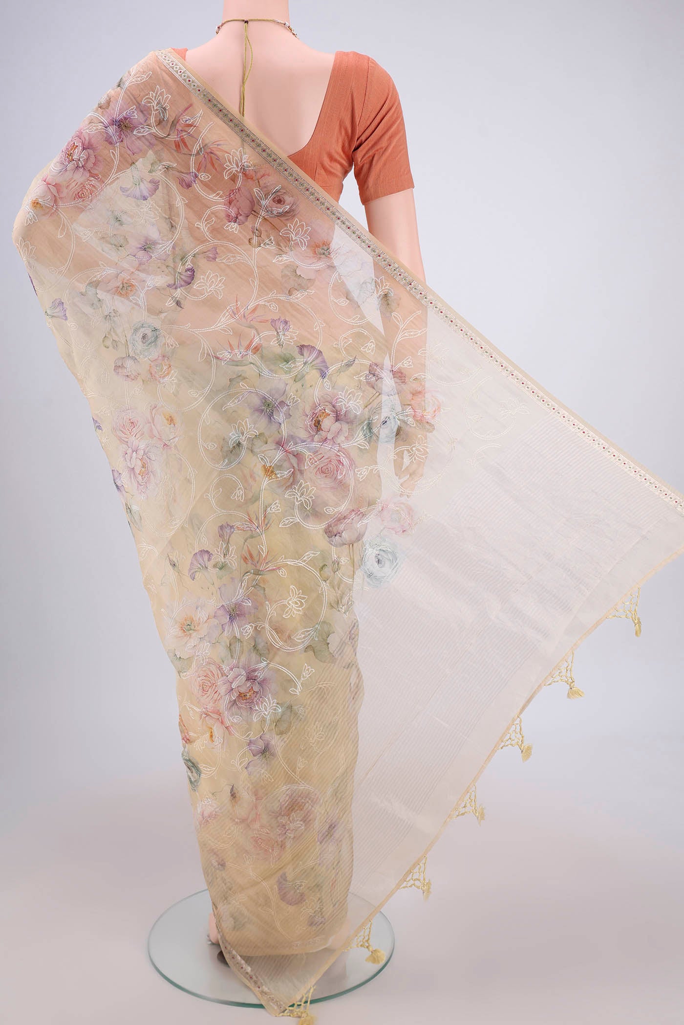 Flat view of Beige Organza Silk Saree with Embroidery on the body and Zari Border. 