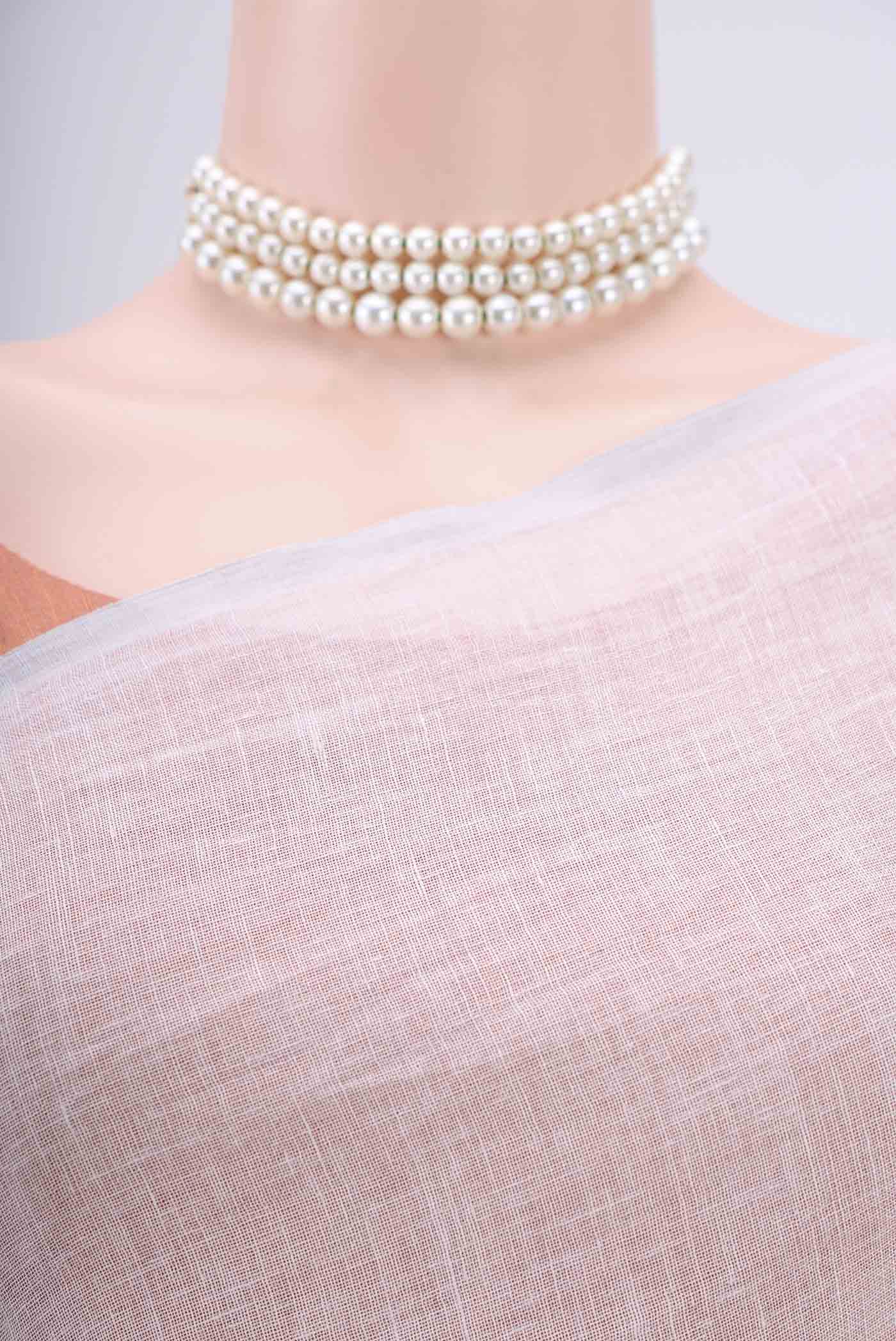 Border image of Off White Linen Saree with Floral Print on the body and Zari Border. 