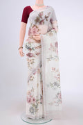 Off White Linen Saree with Floral Print on the body and Zari Border.  displayed on a mannequin