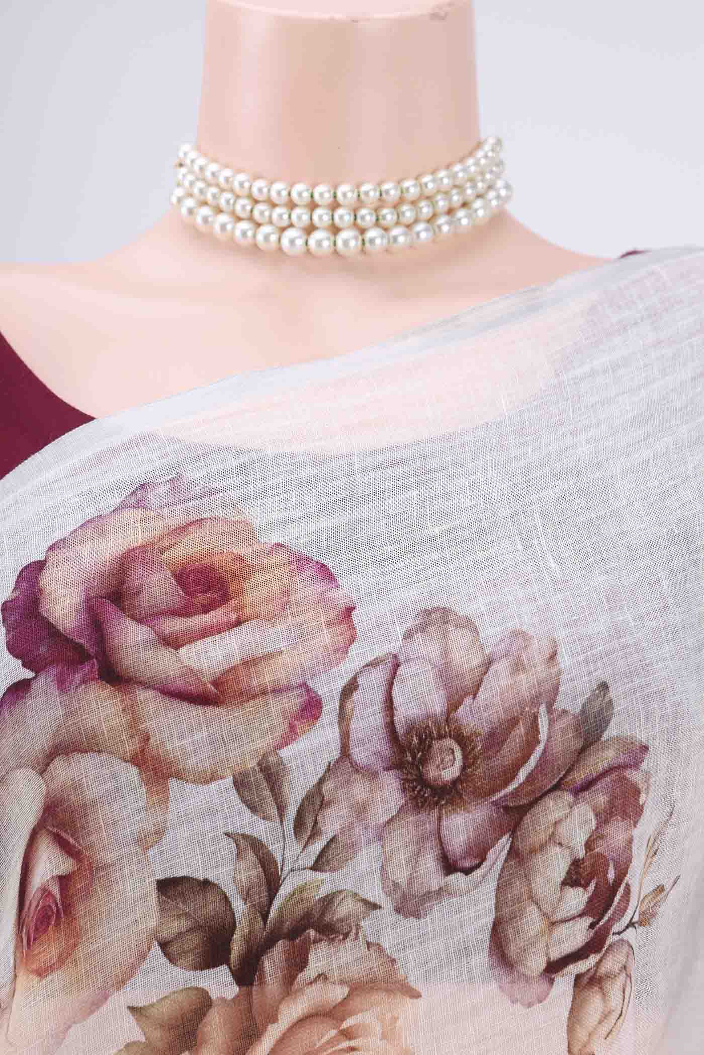 Border image of White Linen Saree with Floral Print on the body and Zari Border. 