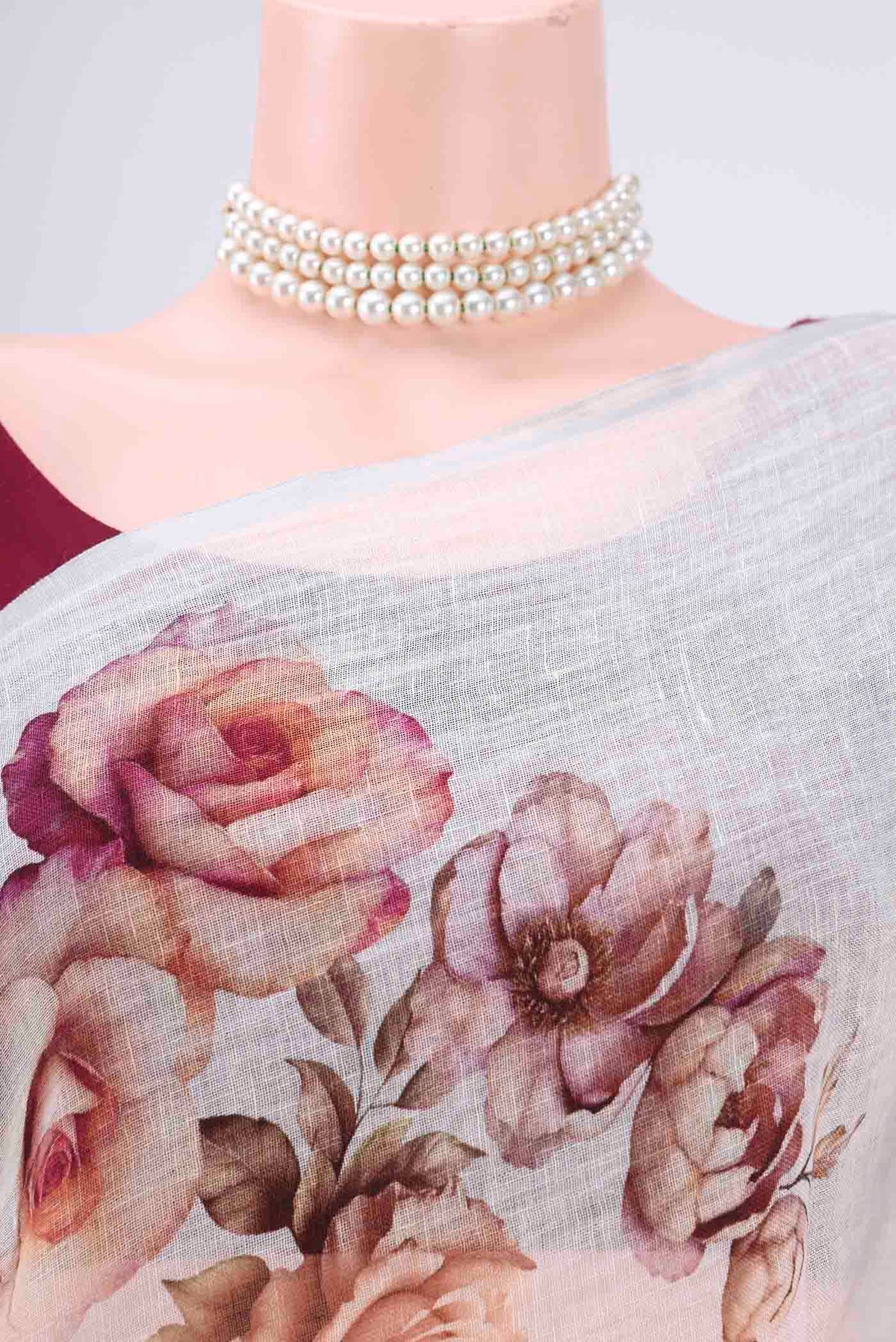 Border image of White Linen Saree with Floral Print on the body and Zari Border. 
