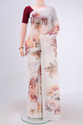 White Linen Saree with Floral Print on the body and Zari Border.  displayed on a mannequin