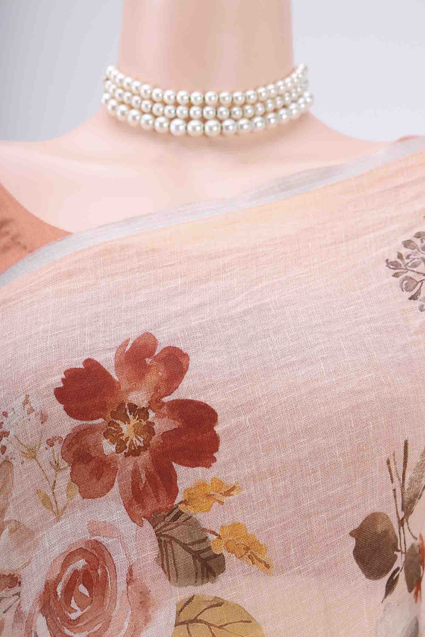 Border image of Peach Linen Saree with Floral Print on the body and Zari Border. 