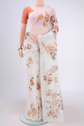 Off White Linen Saree with Floral Print on the body and Zari Border.  displayed on a mannequin