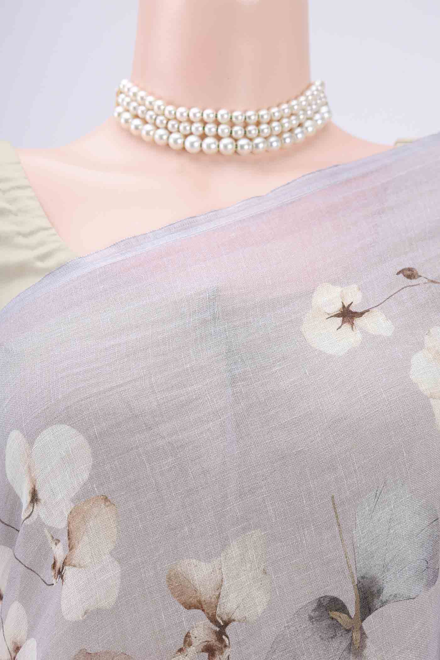 Border image of Grey Linen Saree with Floral Print on the body and Zari Border. 