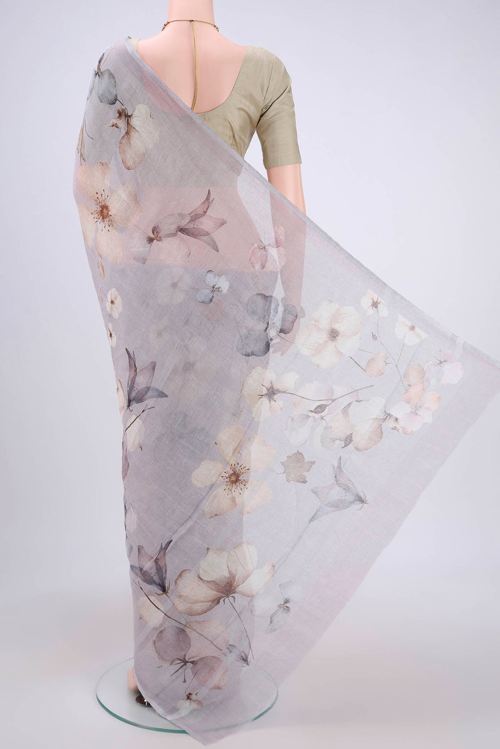 Flat view of Grey Linen Saree with Floral Print on the body and Zari Border. 