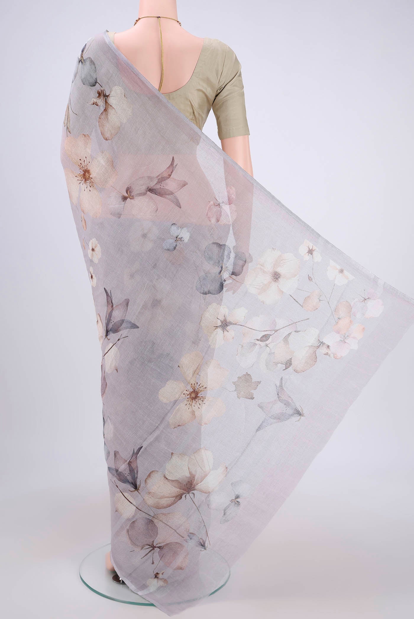 Flat view of Grey Linen Saree with Floral Print on the body and Zari Border. 