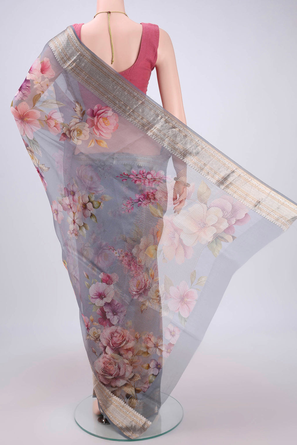 Flat view of Blue Grey Organza Silk Saree with Printed design on the body and Zari Border. 