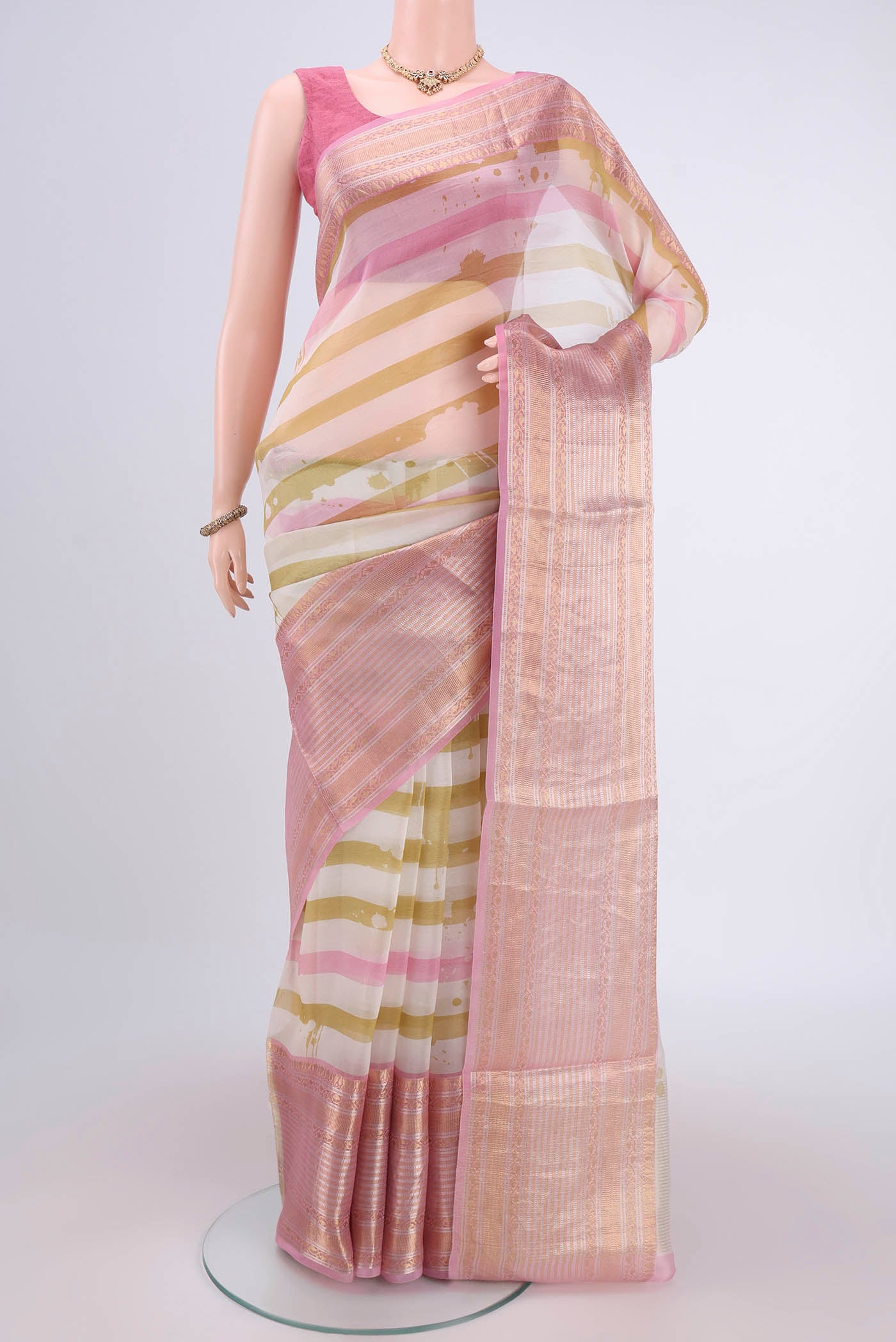 Off White Organza Silk Saree with Stripes on the body and Zari Border.  displayed on a mannequin