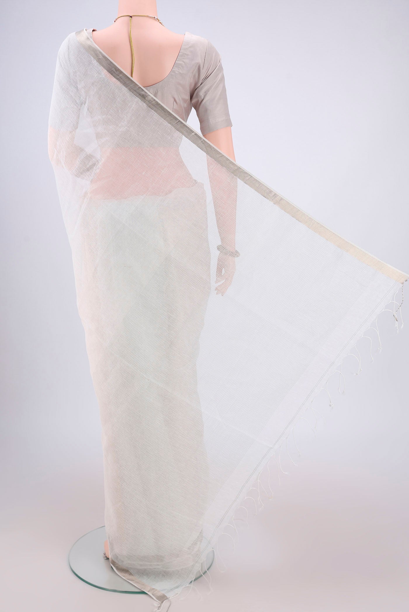 Flat view of Off White Linen Saree with Plain Body and Zari Border. 