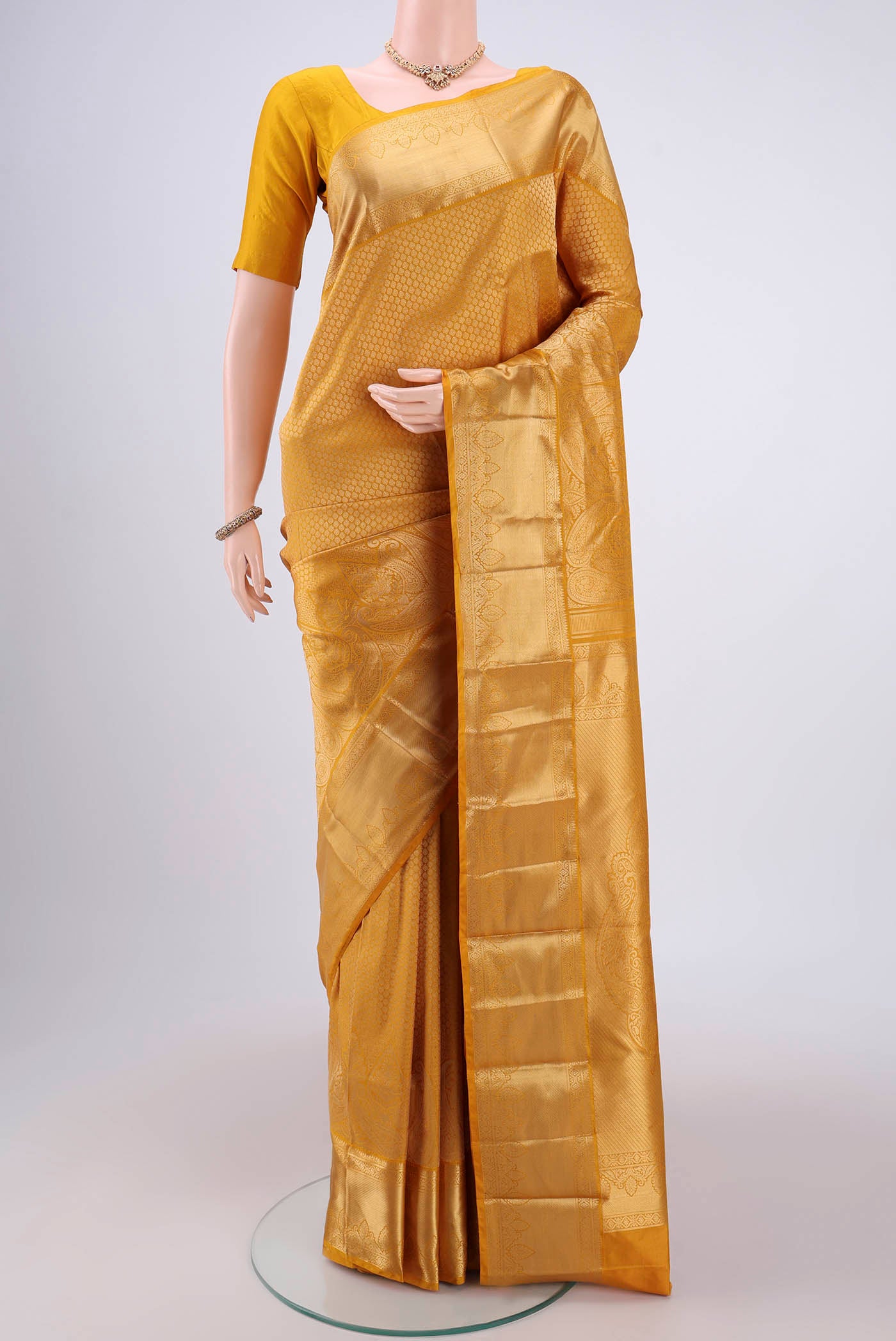 Yellow Bangalore Silk Saree with Zari Brocade on the body and Zari Border.  displayed on a mannequin