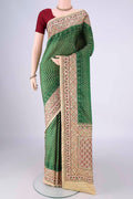 Green Kanchipuram Silk Saree with Pure Ikat on the body and Embroidery Border.  displayed on a mannequin