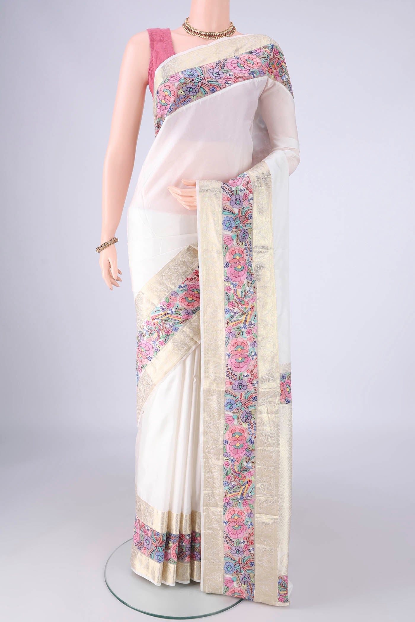 White Kanjivaram Silk Saree with Plain Body and Zari Border.  displayed on a mannequin