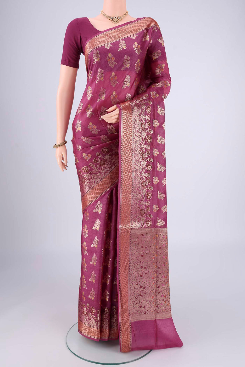 Magenta Banarasi Tussar Silk Saree with Zari And Thread Butta on the body and Zari And Thread Border.  displayed on a mannequin