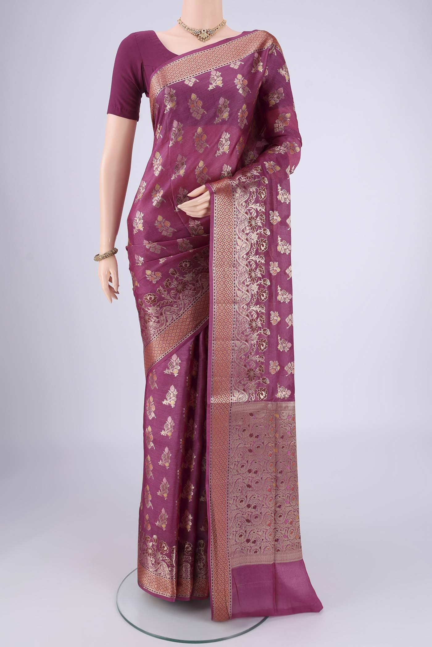Magenta Banarasi Tussar Silk Saree with Zari And Thread Butta on the body and Zari And Thread Border.  displayed on a mannequin