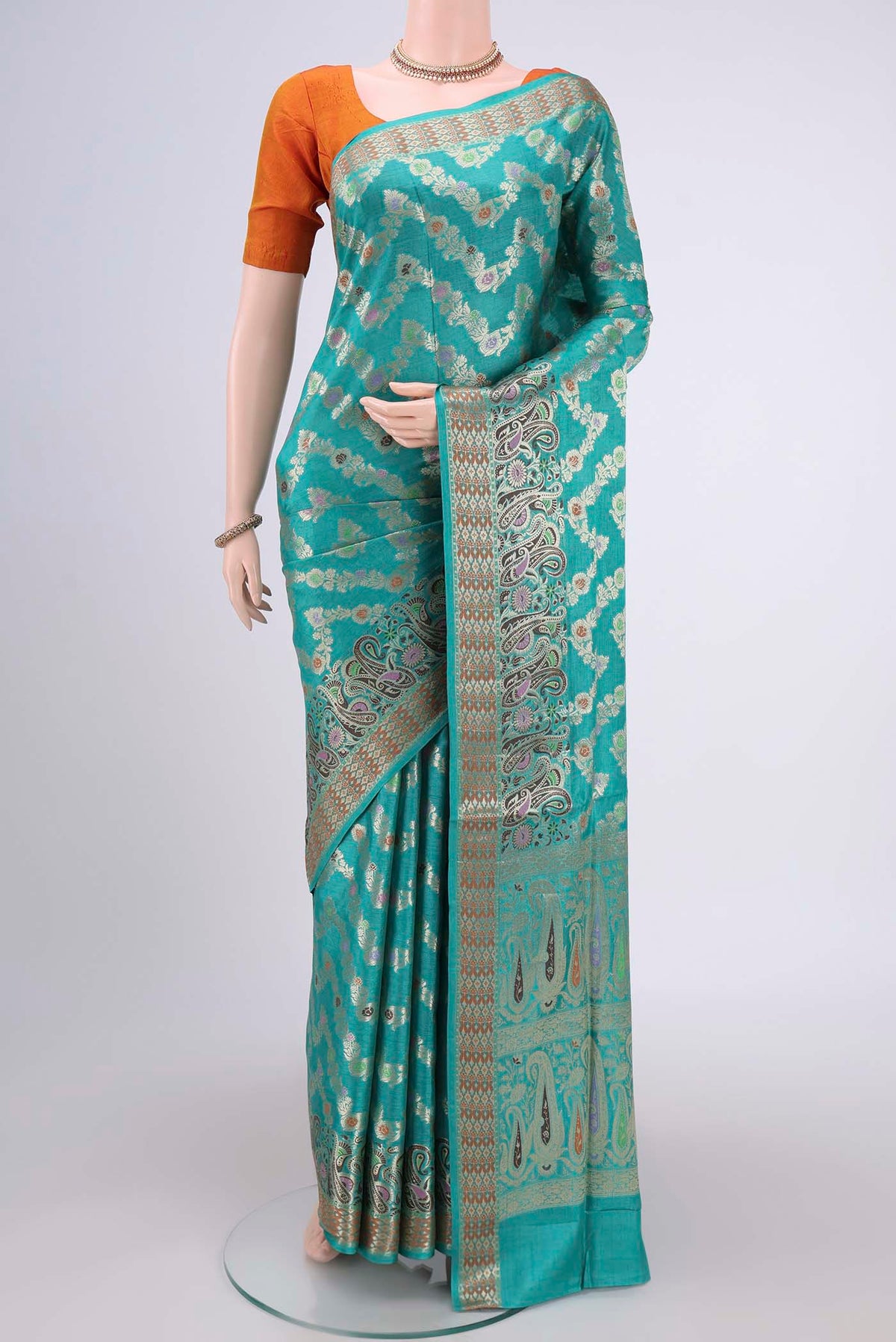 Sea Green Banarasi Tussar Silk Saree with Zari Brocade on the body and Zari And Thread Border.  displayed on a mannequin