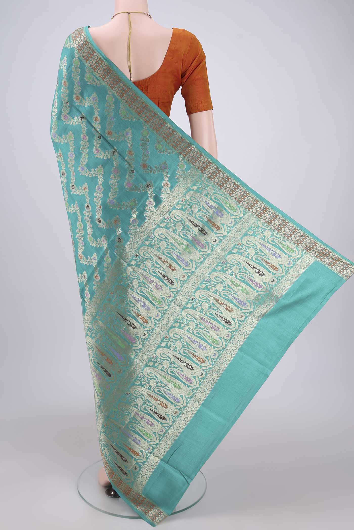 Flat view of Sea Green Banarasi Tussar Silk Saree with Zari Brocade on the body and Zari And Thread Border. 