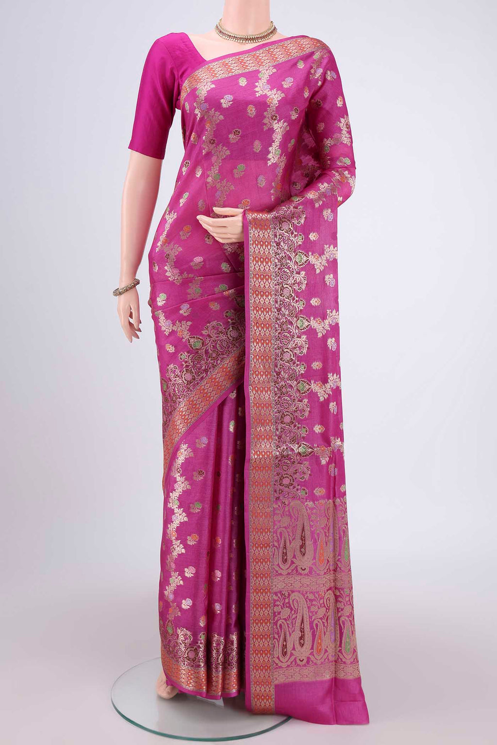 Rani Pink Banarasi Raw Silk Saree with Zari Brocade on the body and Zari And Thread Border.  displayed on a mannequin