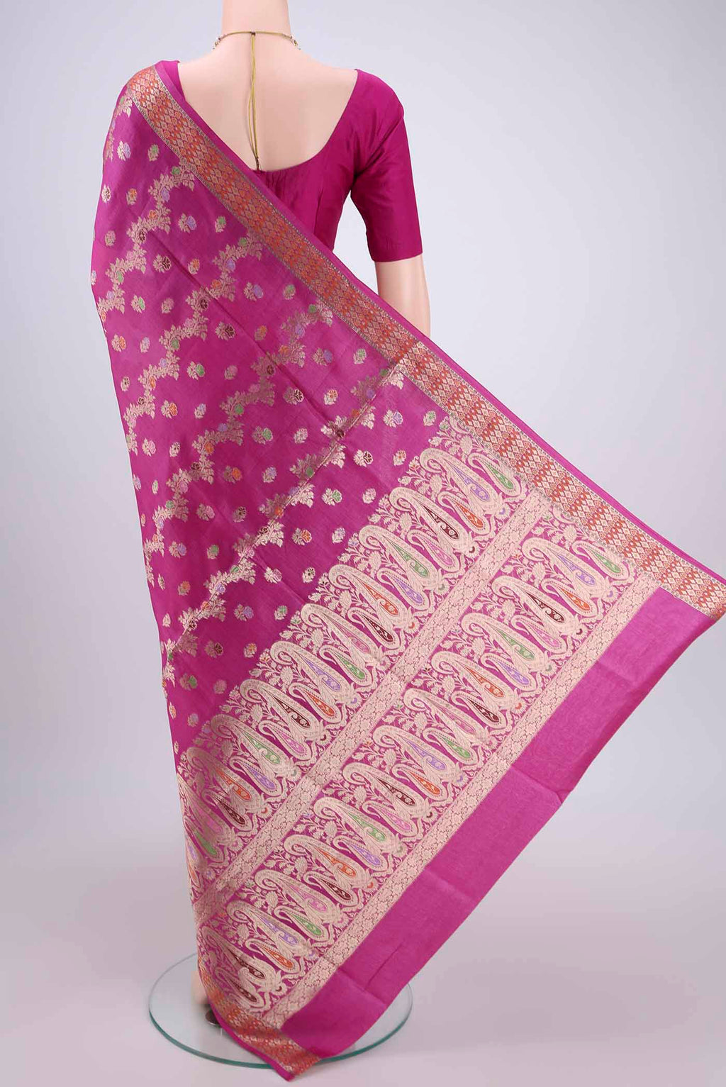 Flat view of Rani Pink Banarasi Raw Silk Saree with Zari Brocade on the body and Zari And Thread Border. 