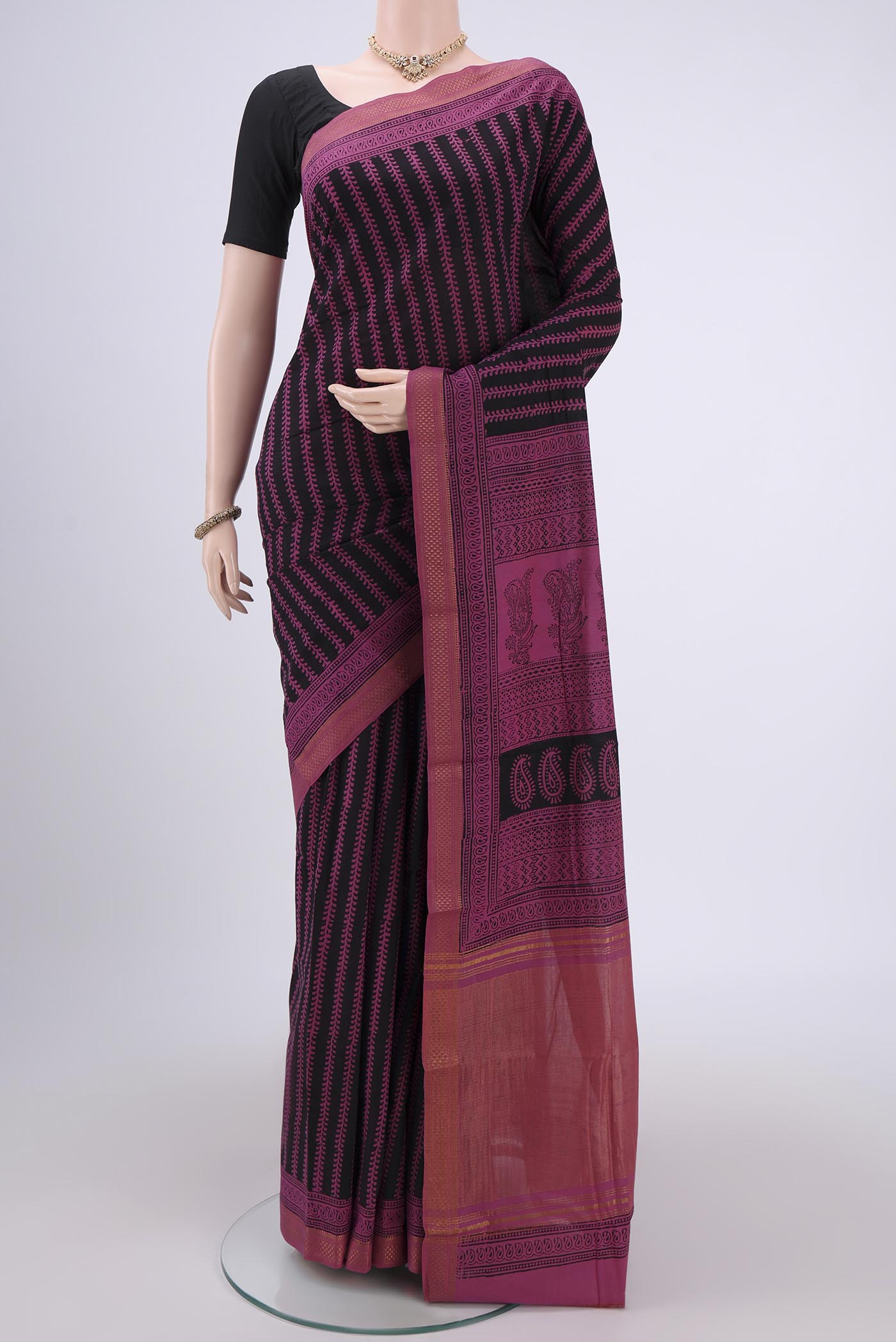 Black Maheshwari Silk Cotton Saree with Stripes on the body and Zari Border.  displayed on a mannequin