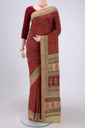 Maroon Maheshwari Silk Cotton Saree with Stripes on the body and Zari Border.  displayed on a mannequin