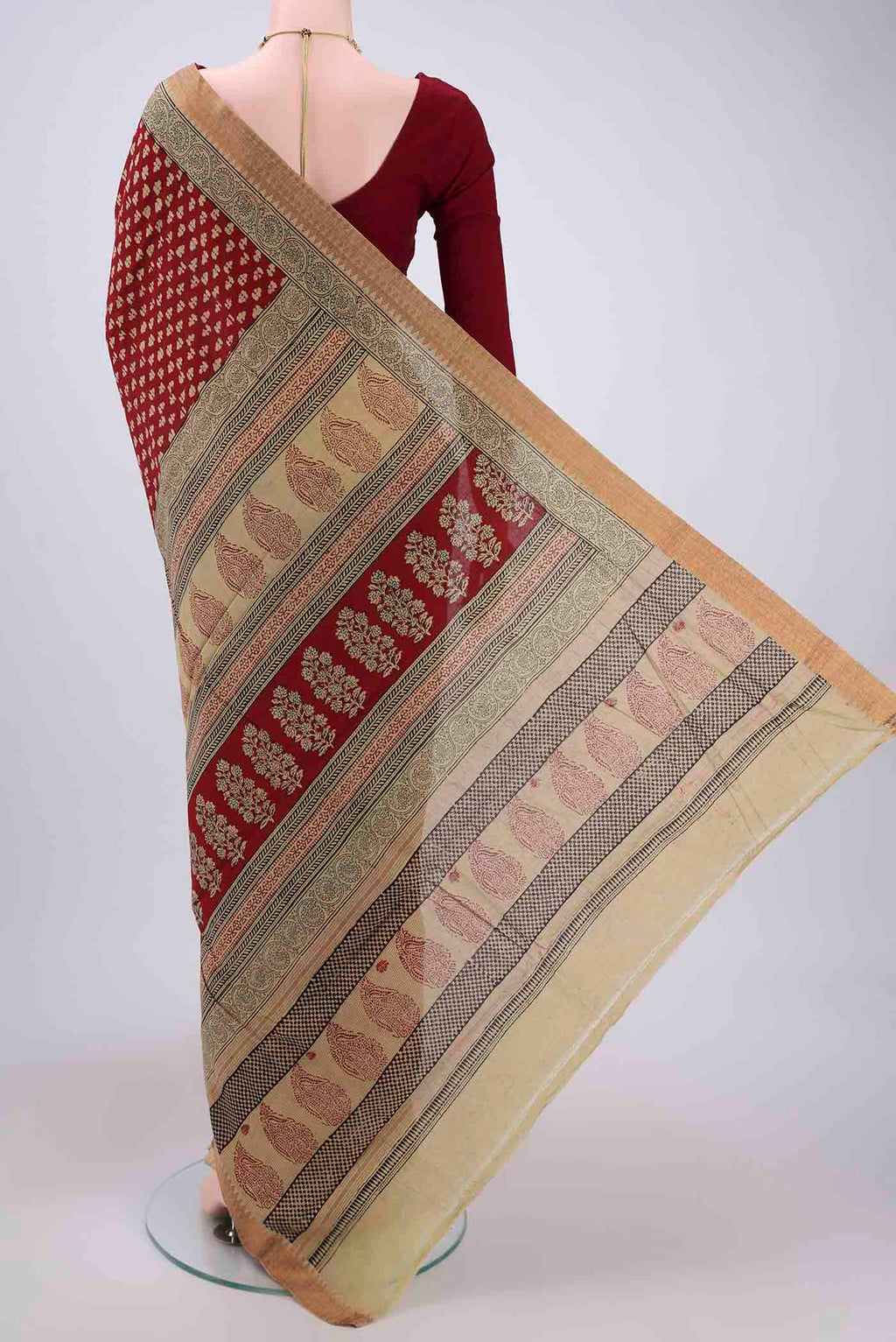 Flat view of Maroon Maheshwari Silk Cotton Saree with Stripes on the body and Zari Border. 